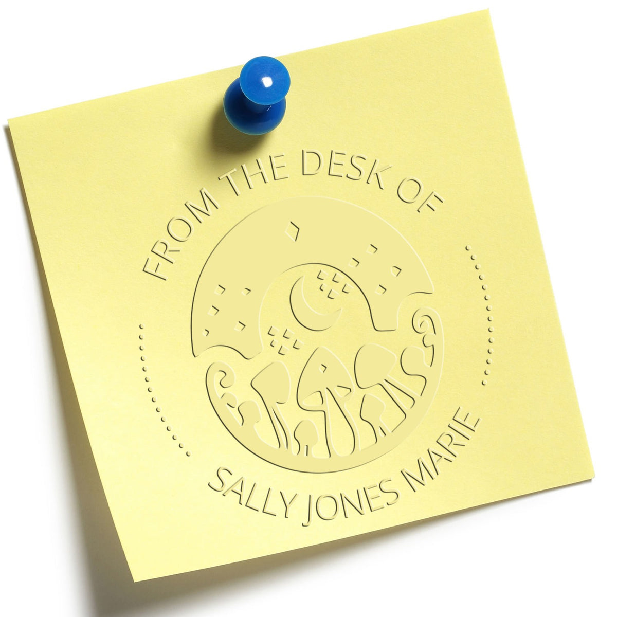 Yellow embossed desk seal/stamp note with blue pushpin, reading From the Desk of Sally Jones Marie.