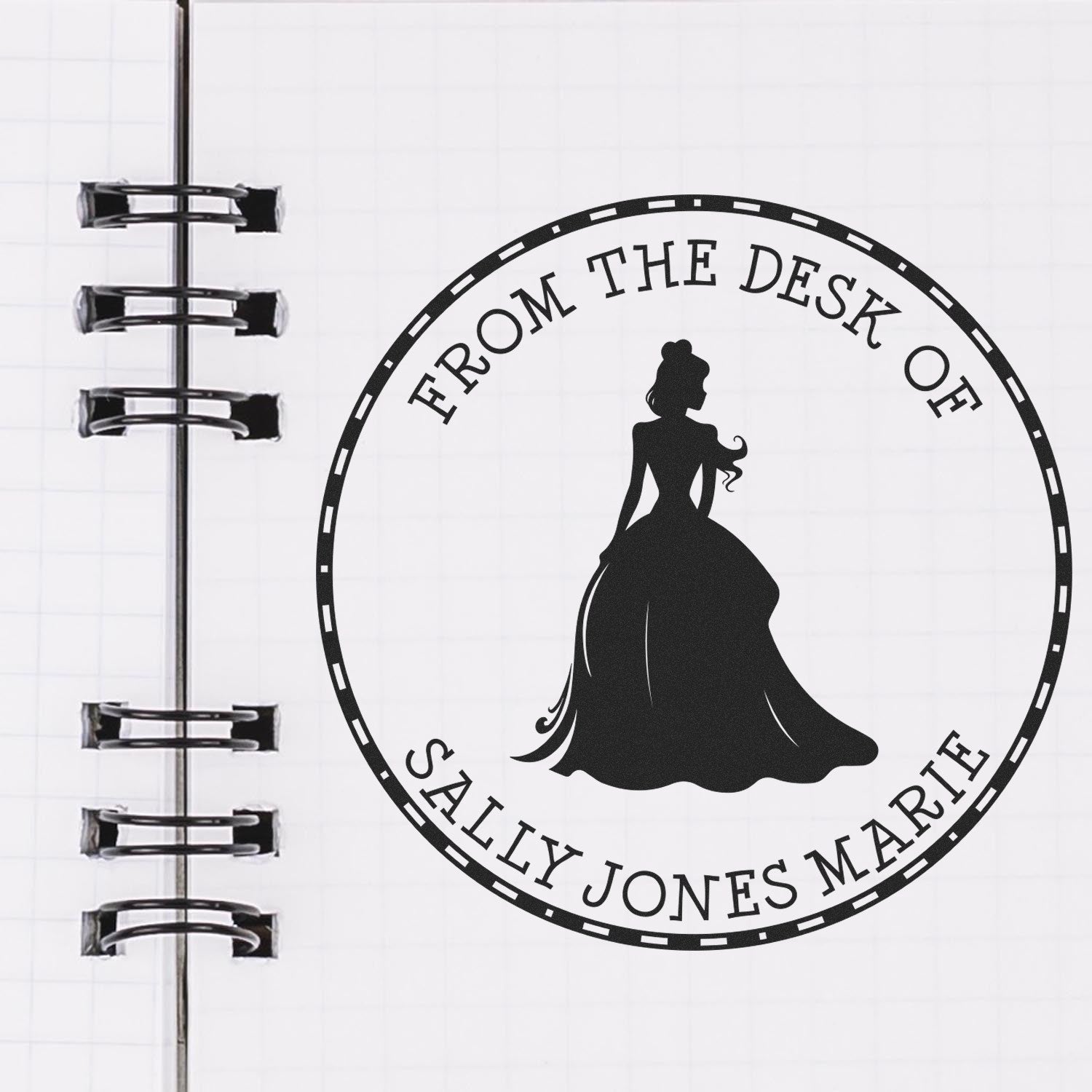 Black custom desk seal stamp with elegant woman silhouette and From the Desk of Sally Jones Marie on a white notebook page.