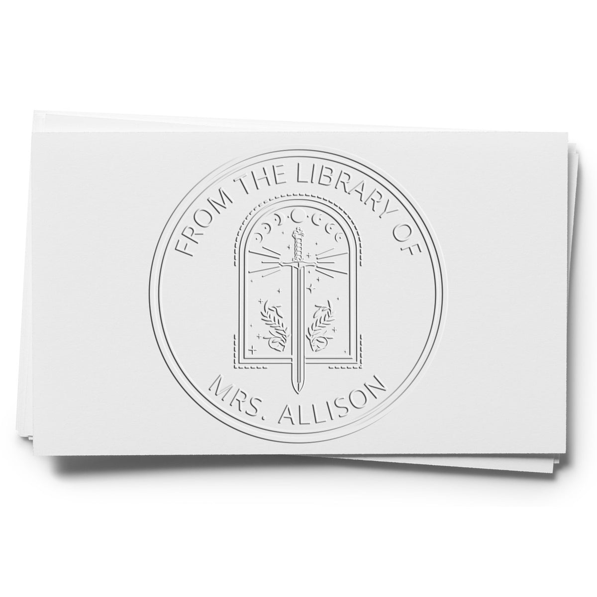 Embossed white library seal stamp on paper, circular design with sword emblem and Mrs. Allison text.