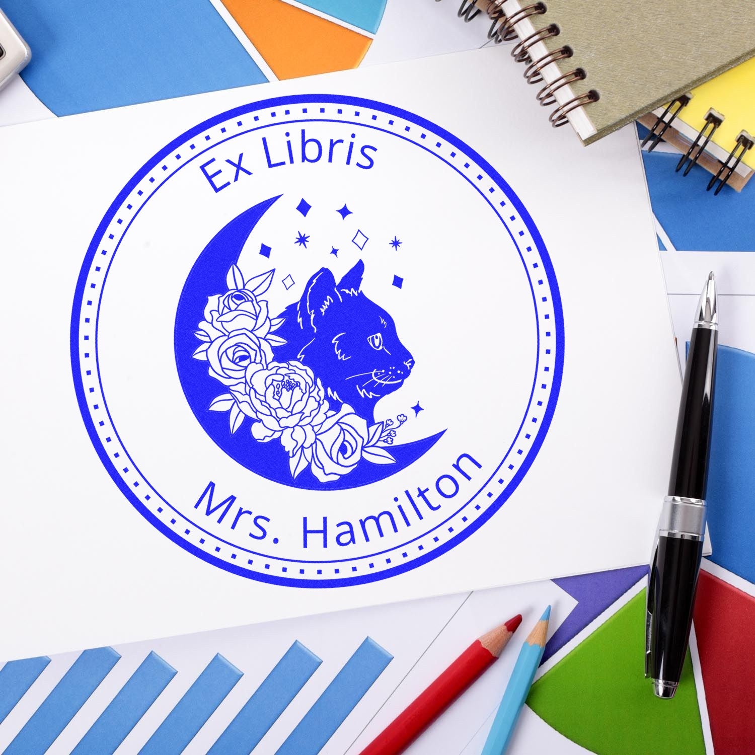 Blue custom ex libris seal stamp with cat silhouette, crescent moon, roses, and Mrs. Hamilton text.