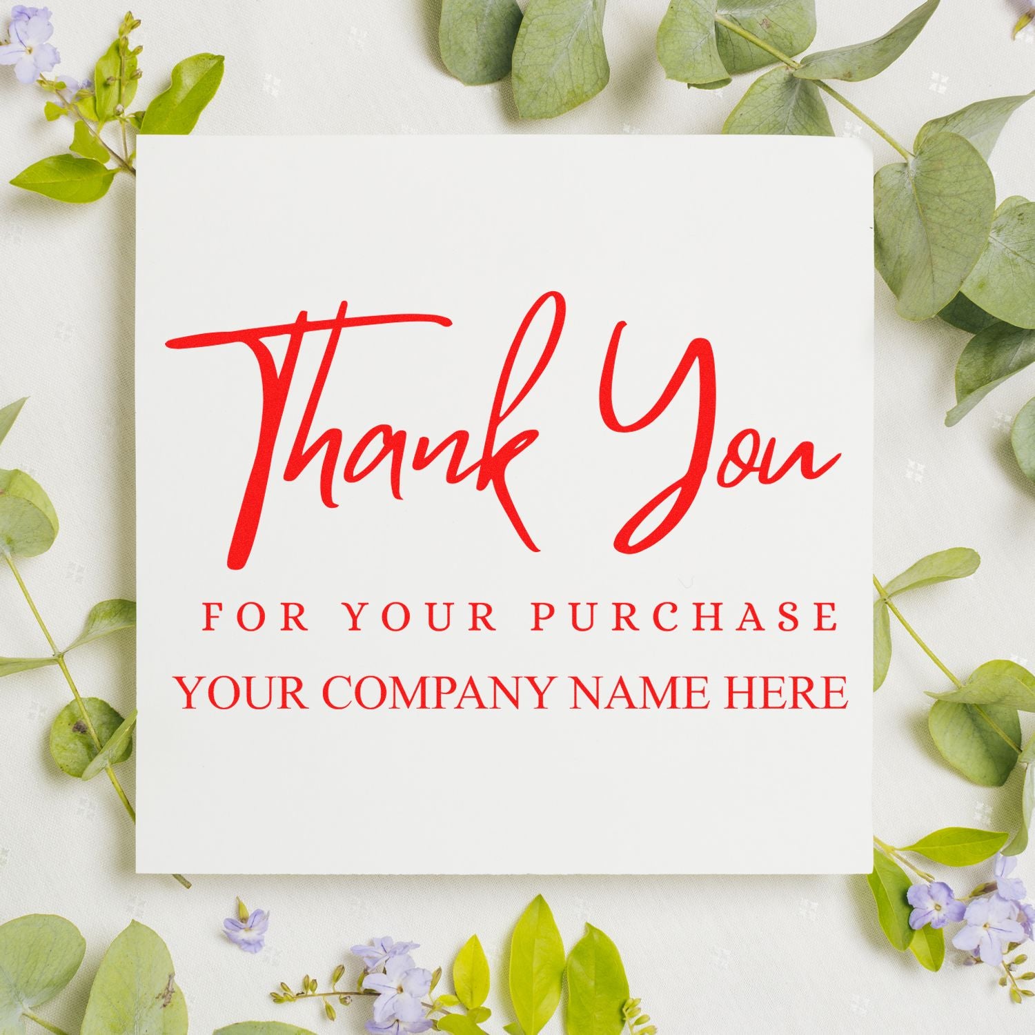 Red custom thank-you stamp seal on a white card, surrounded by green leaves and small purple flowers.