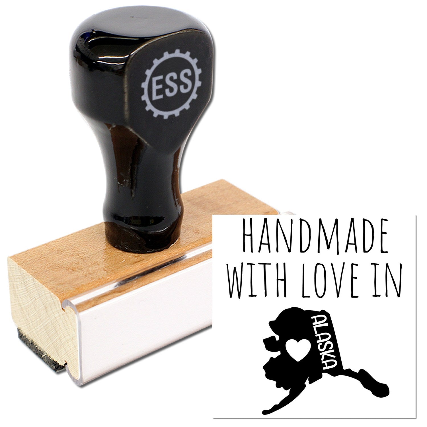 Wood Handle Alaska Handmade with Love Rubber Stamp featuring a black top with 'ESS' logo and a wooden base, alongside a stamped image of Alaska with heart and text.