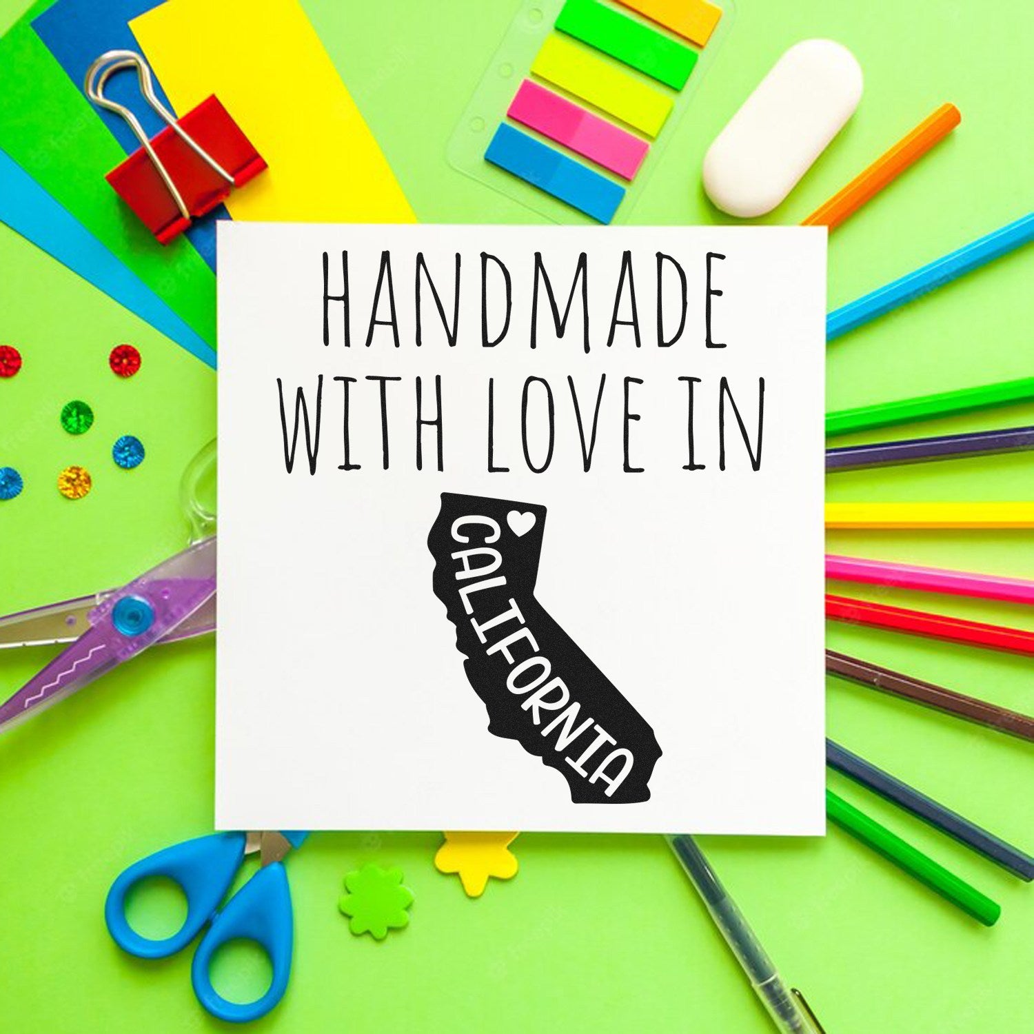 Wood Handle California Handmade with Love Rubber Stamp on colorful craft supplies background, featuring a California state outline with heart design. Perfect for DIY projects and gifts.