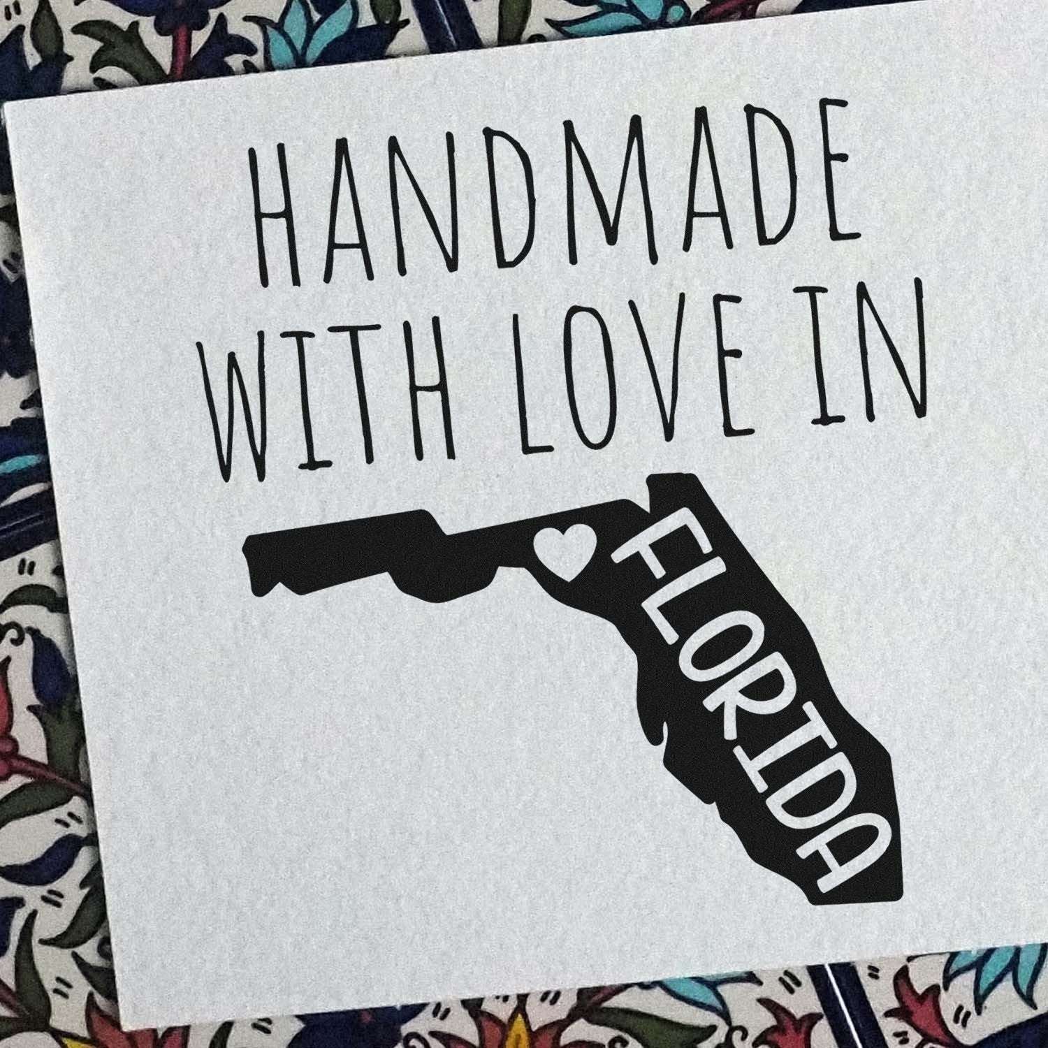 Handmade with Love in Florida Slim Pre-Inked Stamp featuring a heart design within the state outline, perfect for crafts and gifts. Black ink on white paper background.