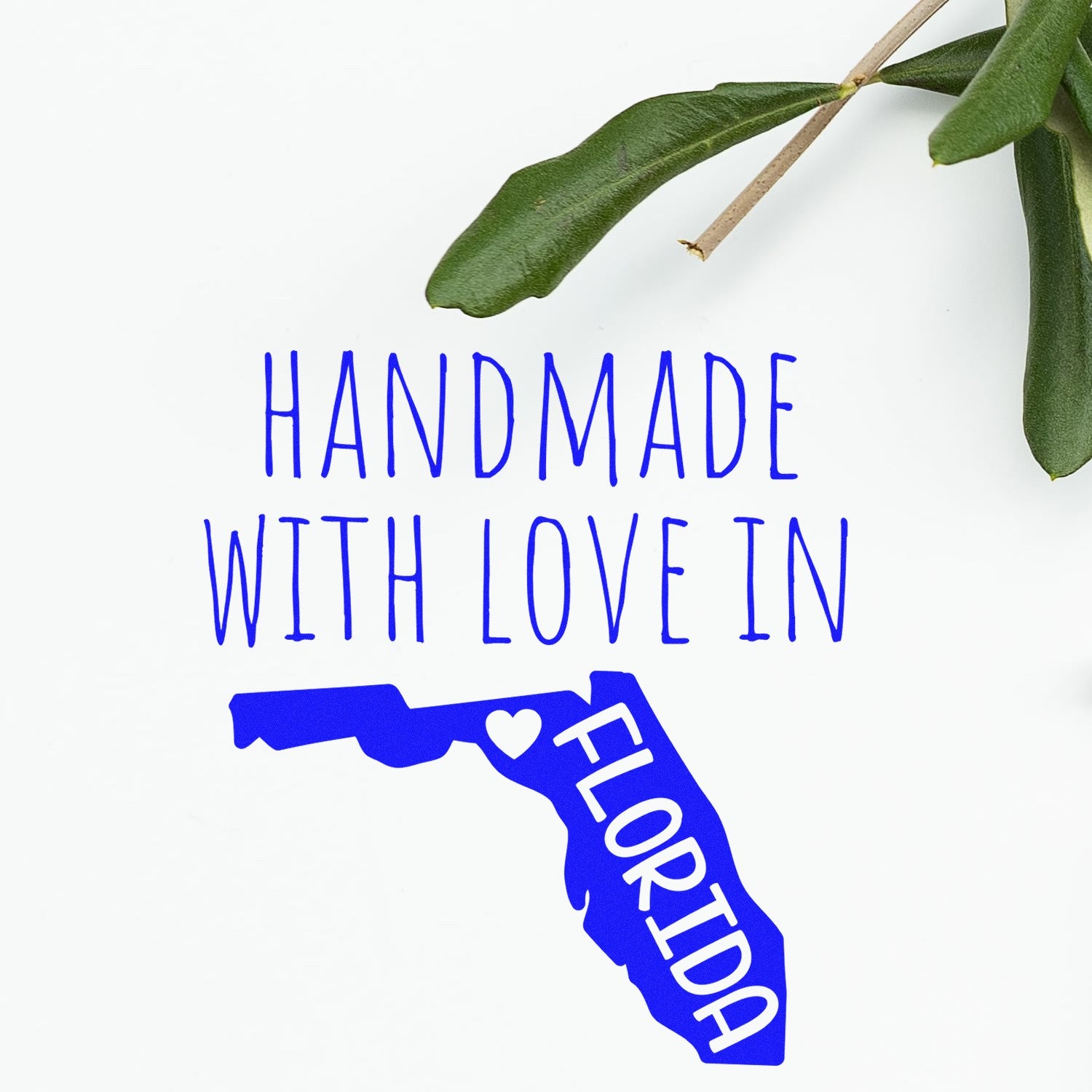 Wood Handle Florida Handmade with Love Rubber Stamp featuring a blue Florida state outline with 'Handmade with Love in Florida' text, next to a green leaf on a white background.