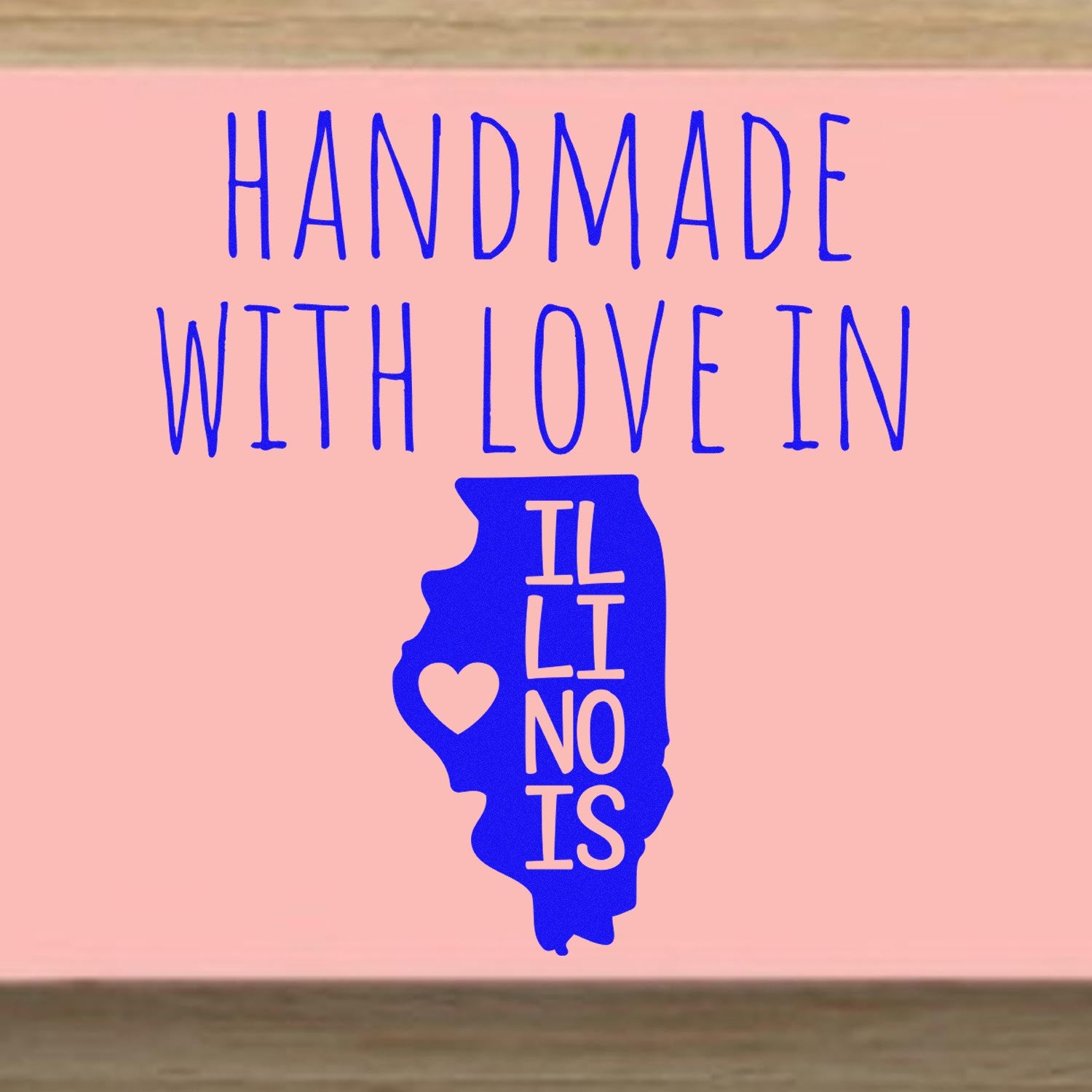 Handmade with Love in Illinois Slim Pre-Inked Stamp featuring a blue Illinois state outline with a heart, on a pink background.