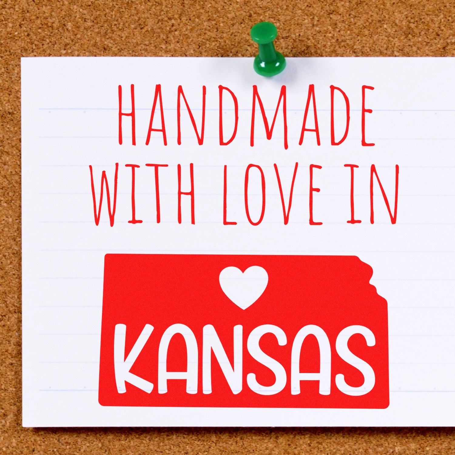 Self-Inking Kansas Handmade with Love Stamp featuring a red Kansas state outline with 'Handmade with Love in Kansas' text, pinned on a corkboard. Perfect for crafts and gifts.