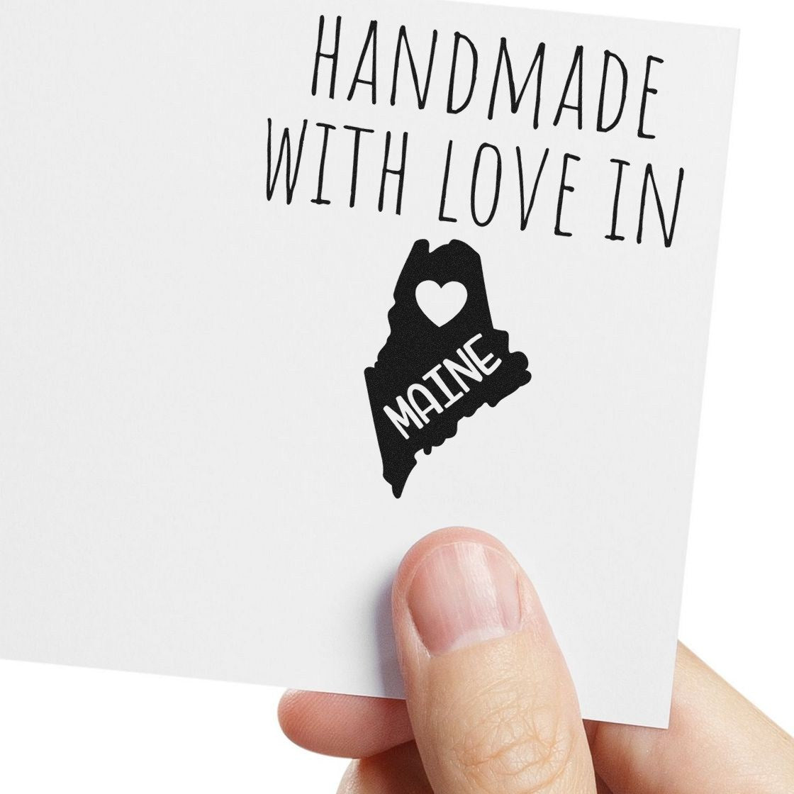 Self-Inking Maine Handmade with Love Stamp featuring a black silhouette of Maine with a heart, perfect for adding a personal touch to crafts and gifts.