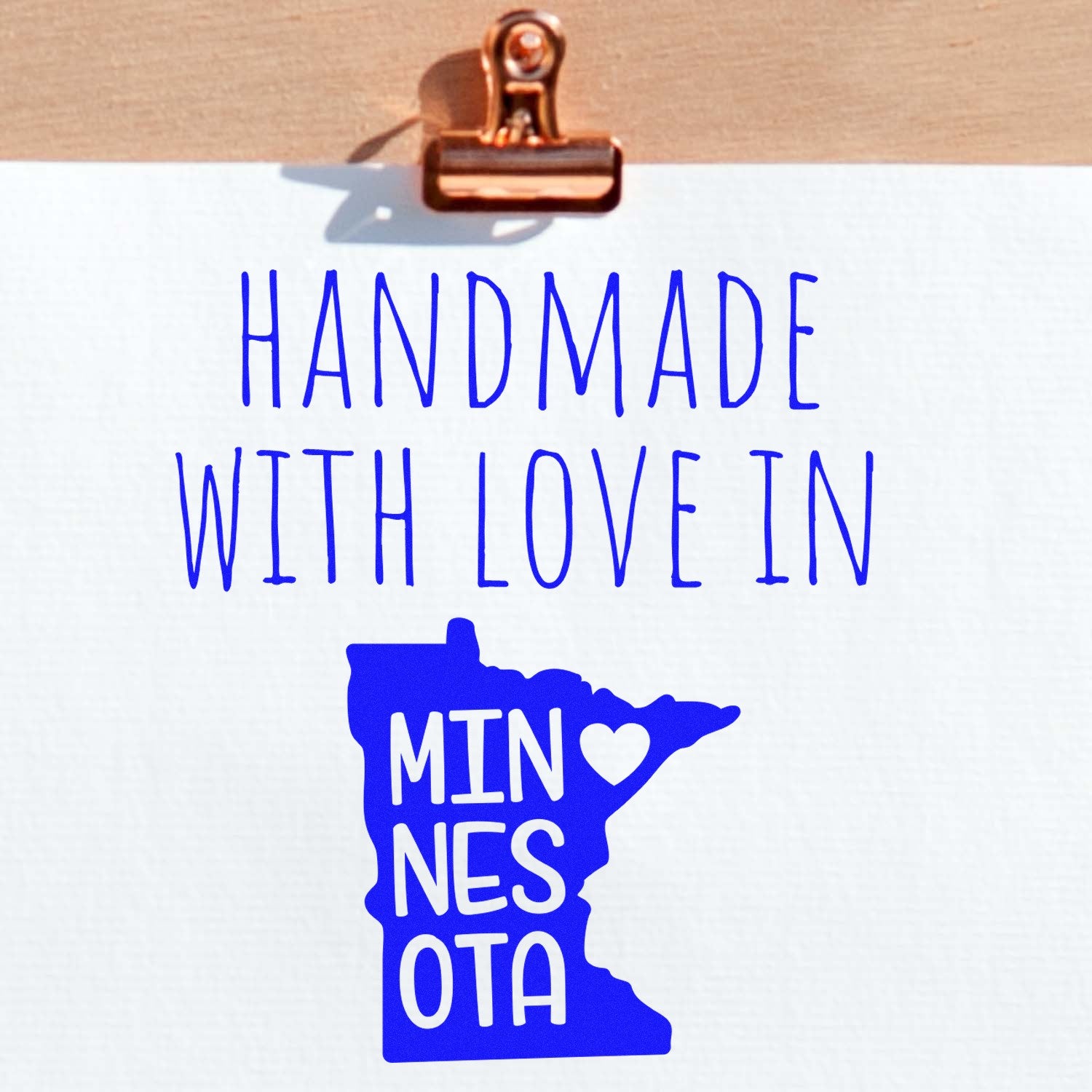 PSI Pre-Inked Handmade with Love in Minnesota stamp featuring blue text and a heart on a white background, highlighting its handcrafted origin.