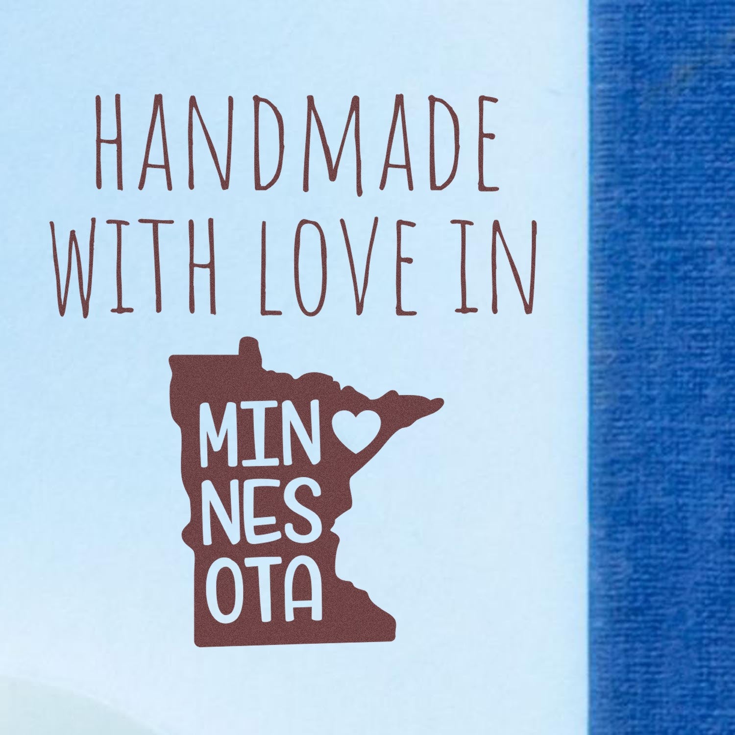 Wood Handle Minnesota Handmade with Love Rubber Stamp featuring a heart and state outline, perfect for crafts and gifts. High-quality design on a light blue background.