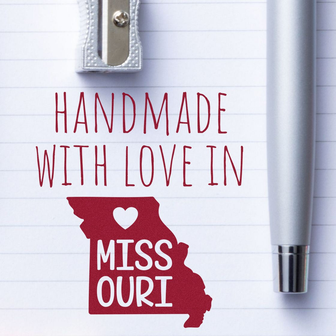 Self-Inking Missouri Handmade with Love Stamp on notepad, featuring a red Missouri state outline with heart, silver pen, and sharpener. Perfect for crafts and personalized gifts.