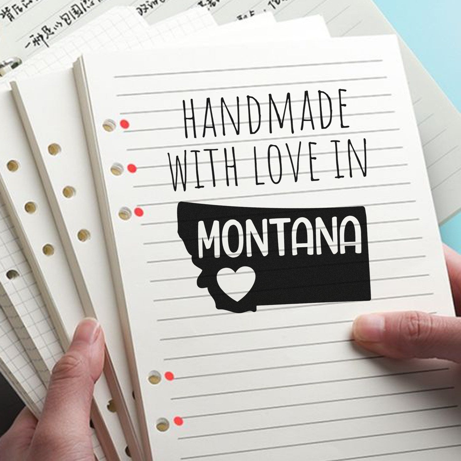 PSI Pre-Inked Handmade with Love in Montana stamp on lined paper, featuring a heart and Montana state outline design.