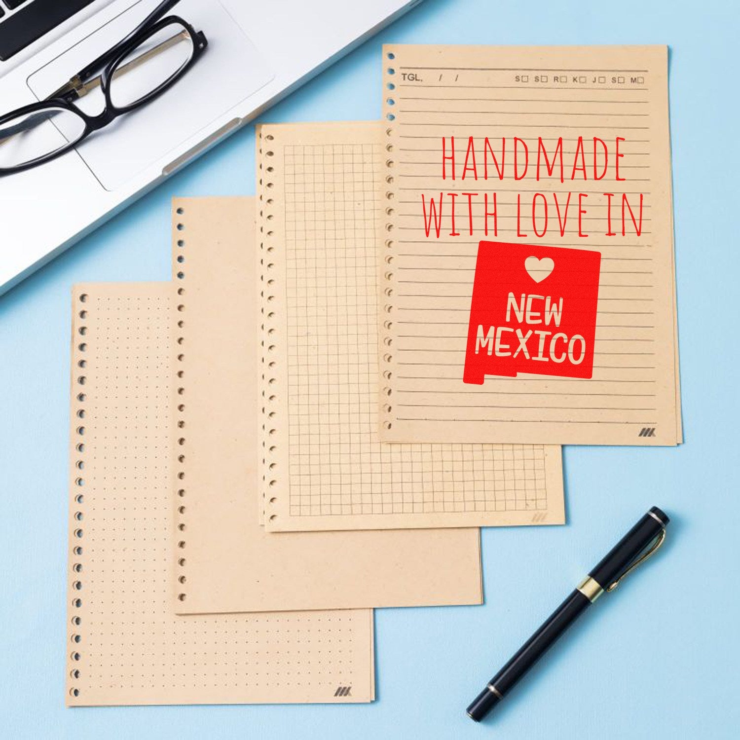 Wood Handle New Mexico Handmade with Love Rubber Stamp on a notepad, showcasing its intricate design and craftsmanship. Perfect for adding a personal touch to stationery and crafts.