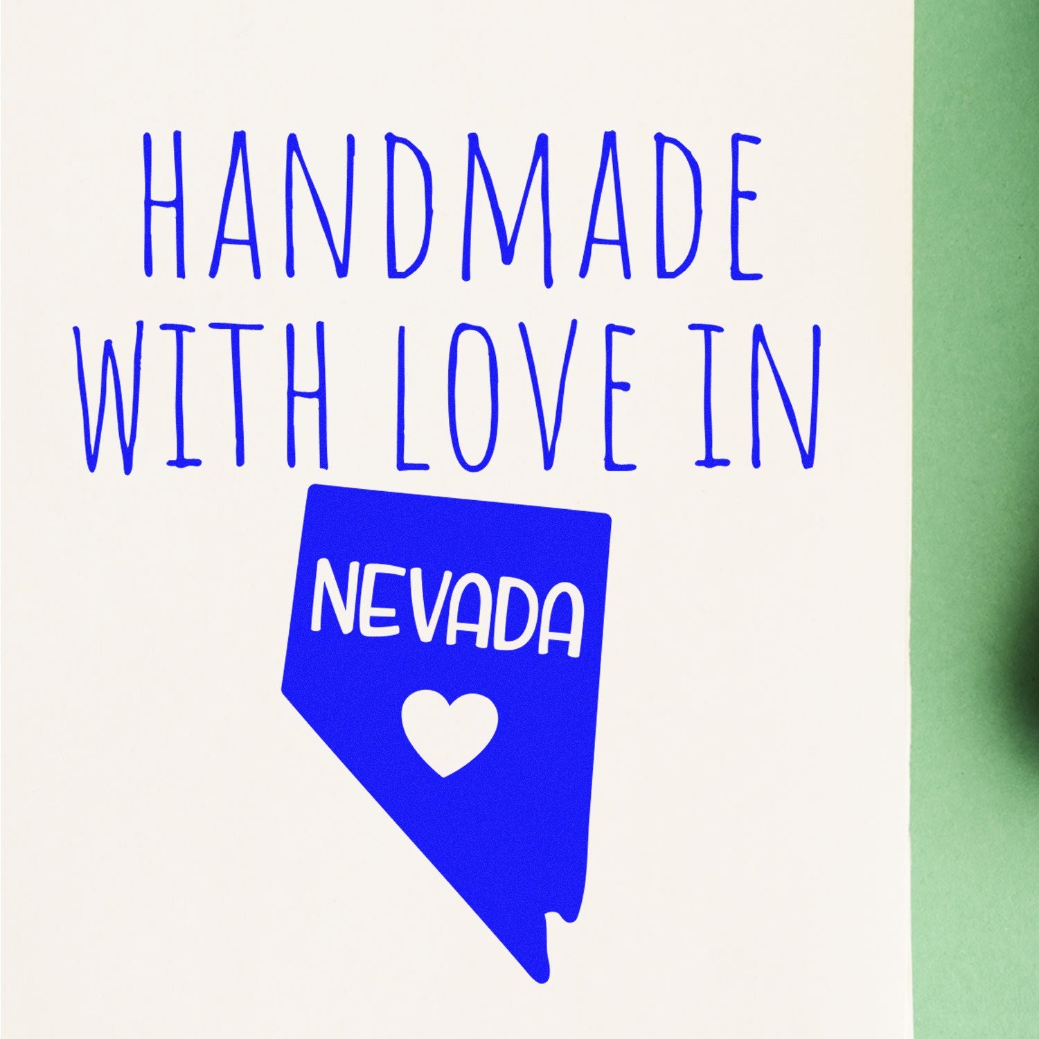 Wood Handle Nevada Handmade with Love Rubber Stamp featuring a blue Nevada state outline with Handmade with Love text, perfect for crafts and personalized projects.