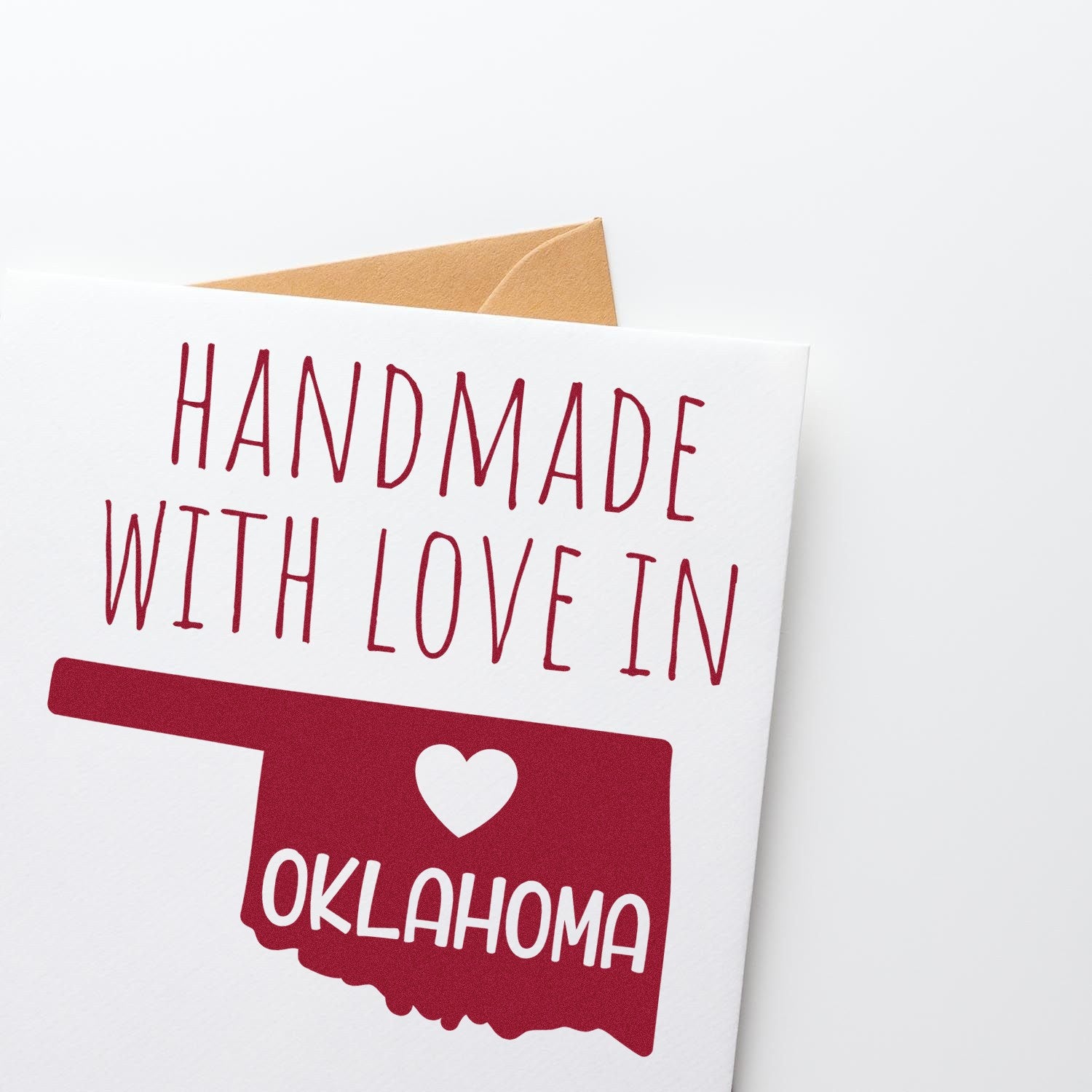 Self-Inking Oklahoma Handmade with Love Stamp featuring a red Oklahoma state outline and heart design on a white card. Perfect for adding a personal touch to crafts and gifts.