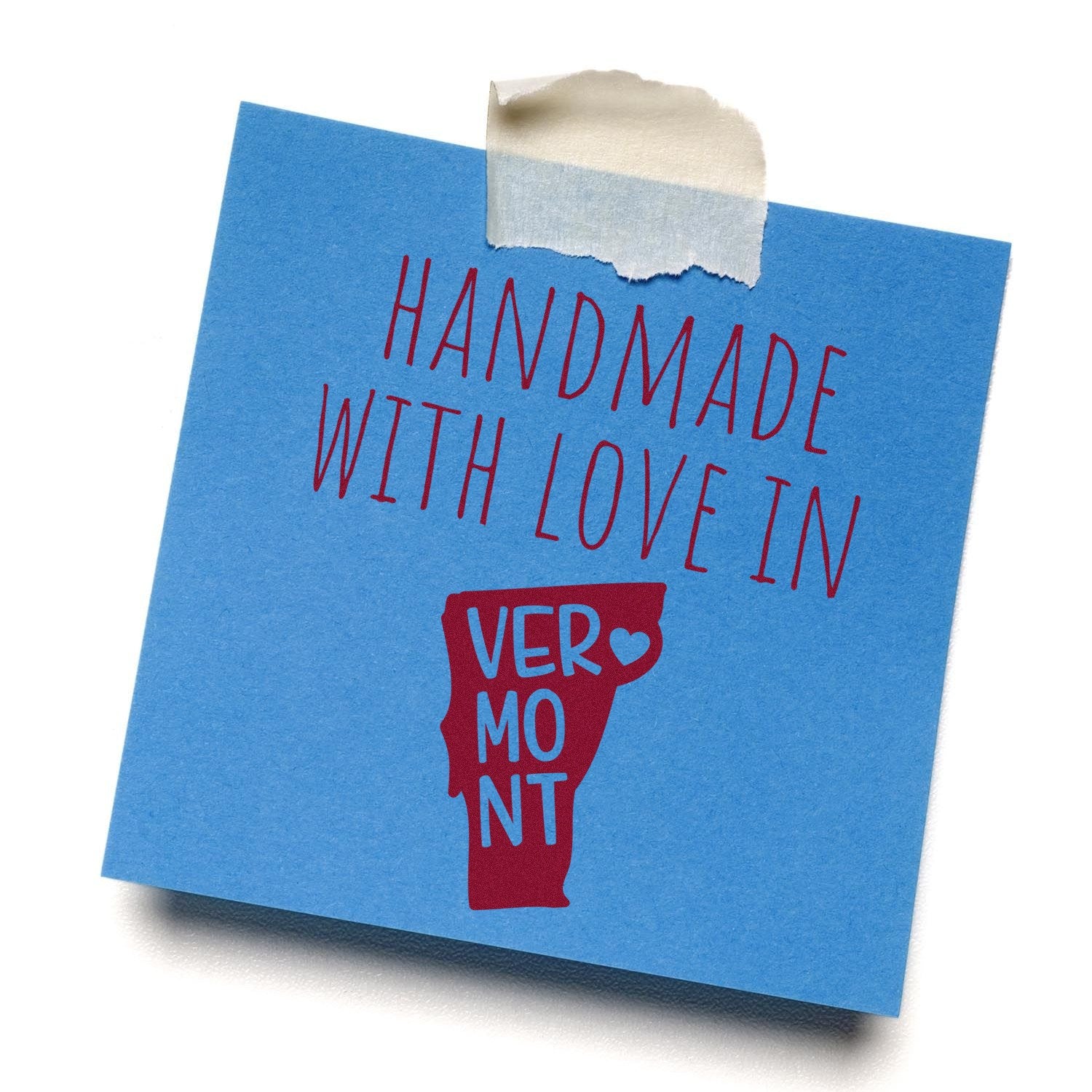 Self-Inking Vermont Handmade with Love Stamp on blue paper, featuring red text and a Vermont state outline with a heart. Perfect for crafts and gifts.