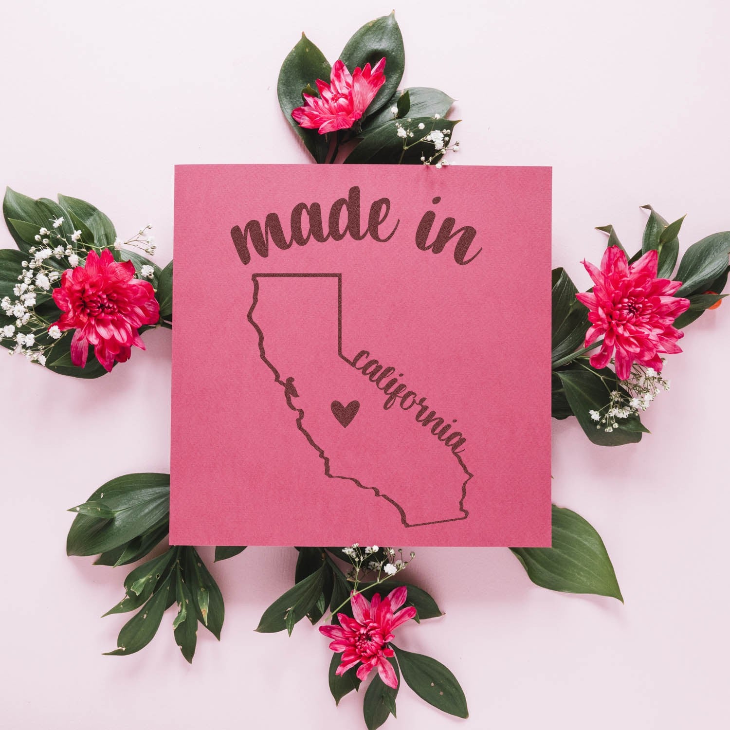 Self-Inking Handmade with Love in California Stamp featuring a pink design with a heart on the California map, surrounded by vibrant pink flowers and green leaves.