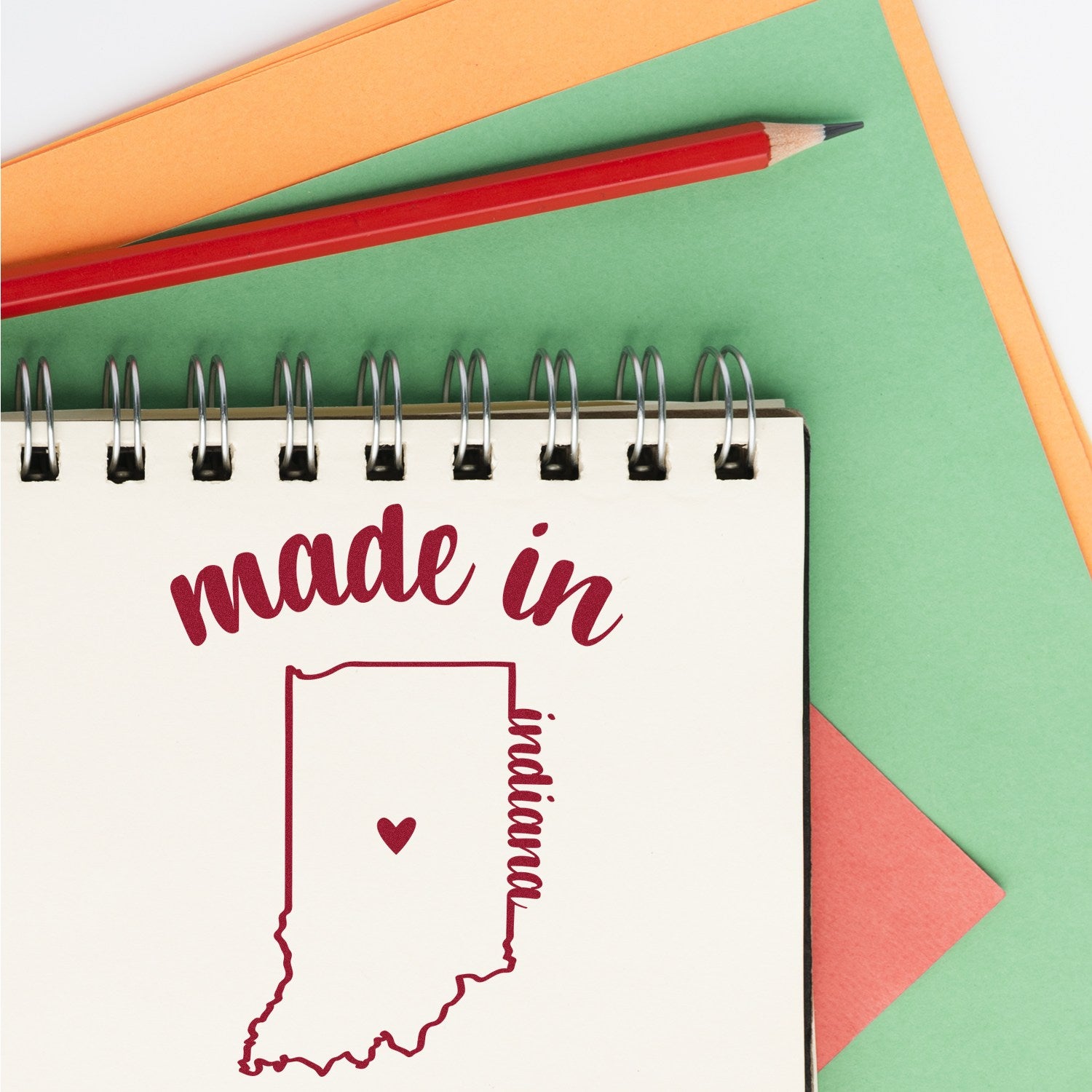 Self-Inking Handmade with Love in Indiana Stamp on a notepad with a red pencil, featuring a heart and Indiana outline. Perfect for crafts and gifts.