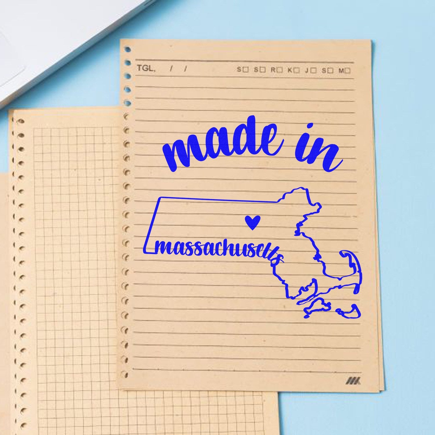 Self-Inking Handmade with Love in Massachusetts Stamp on lined paper, featuring a blue outline of Massachusetts with a heart. Perfect for crafts and personalized projects.