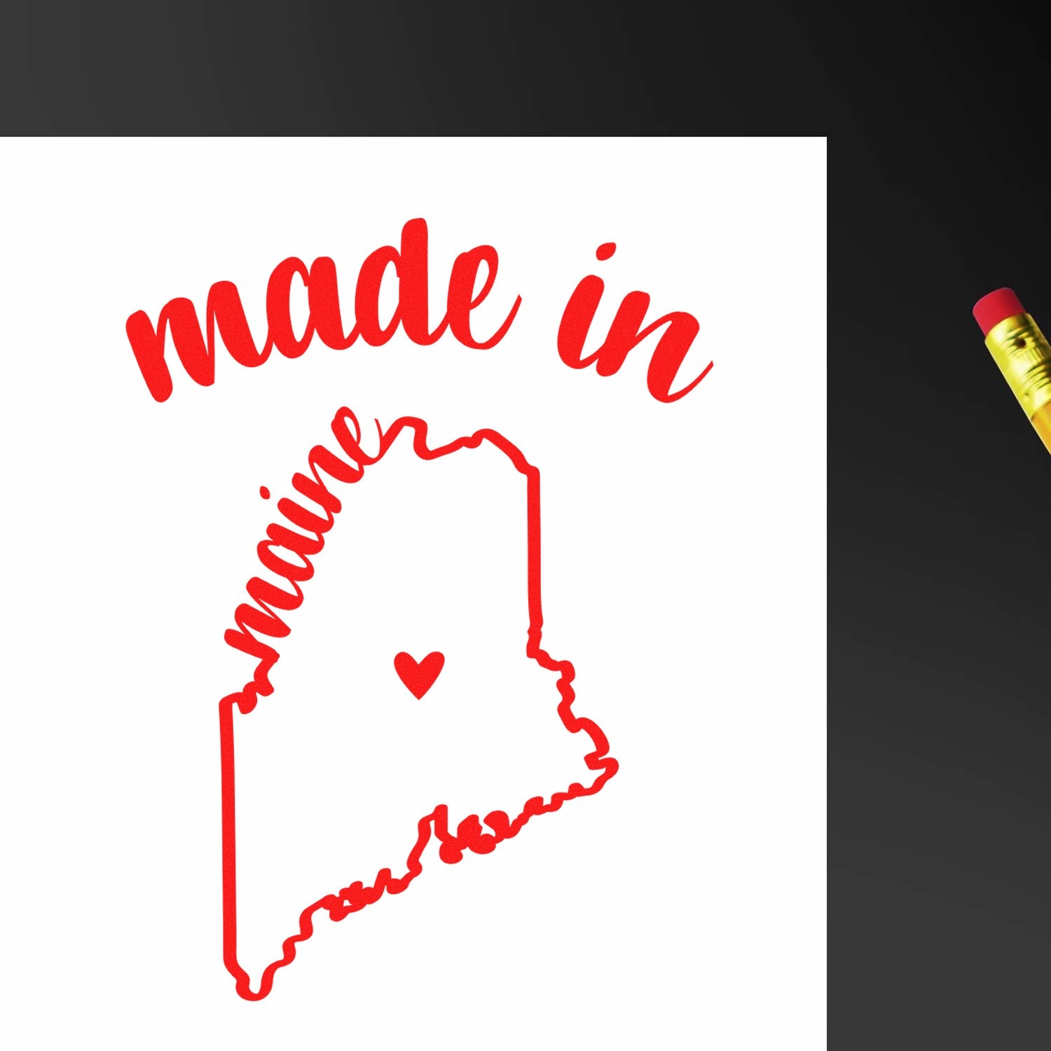 Self-Inking Handmade with Love in Maine Stamp featuring a red outline of Maine with a heart, and 'made in maine' text. Perfect for crafts and gifts. Includes a pencil for scale.