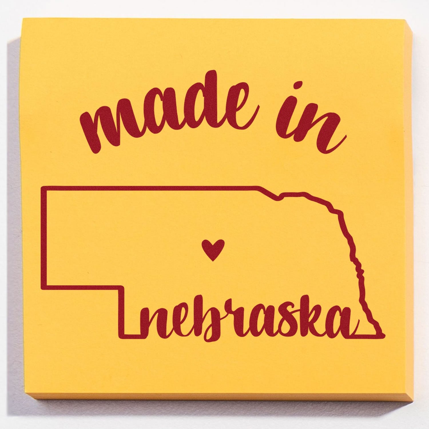 Slim Pre-Inked Stamp Nebraska Made in Stamp featuring a yellow square design with 'made in nebraska' text and state outline, perfect for crafts and personalization.