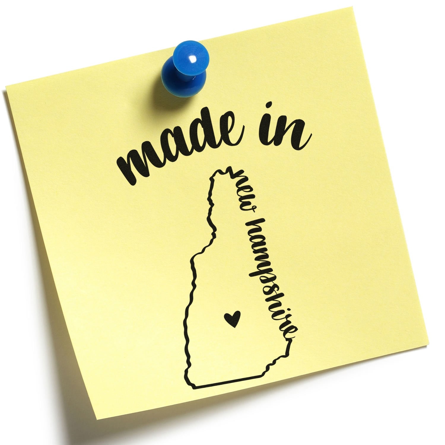 Made in New Hampshire Stamp Pre-Inked on yellow paper with state outline and heart, pinned with a blue pushpin.