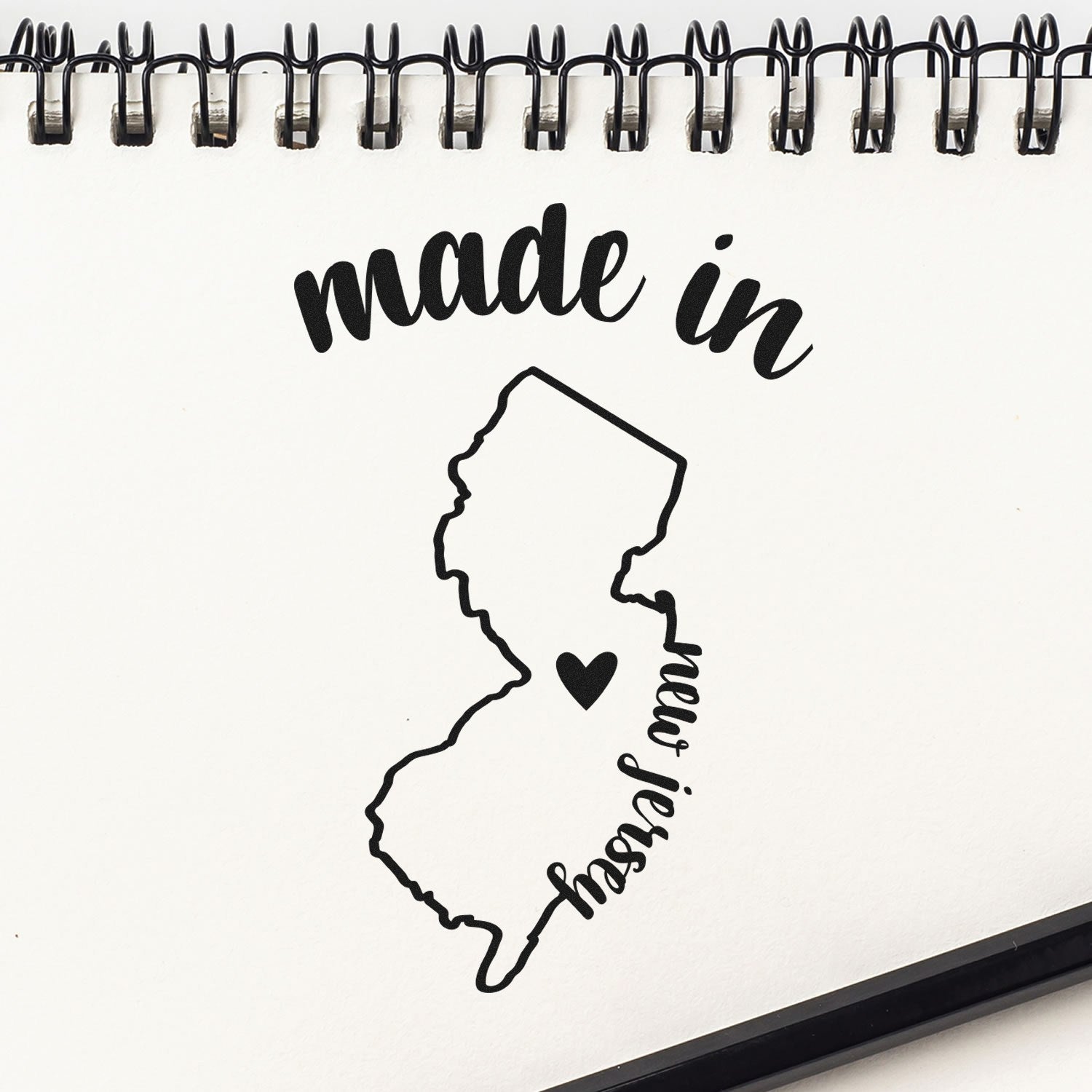 Self-Inking Handmade with Love in New Jersey Stamp featuring a map outline of New Jersey with a heart, perfect for adding a personal touch to crafts and gifts.