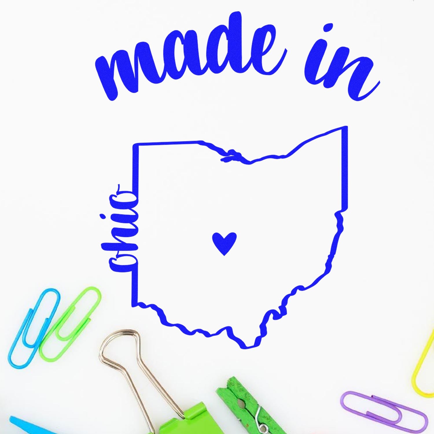 Made in Ohio Stamp Pre-Inked featuring a blue outline of Ohio with a heart, surrounded by colorful paper clips and a binder clip on a white background.