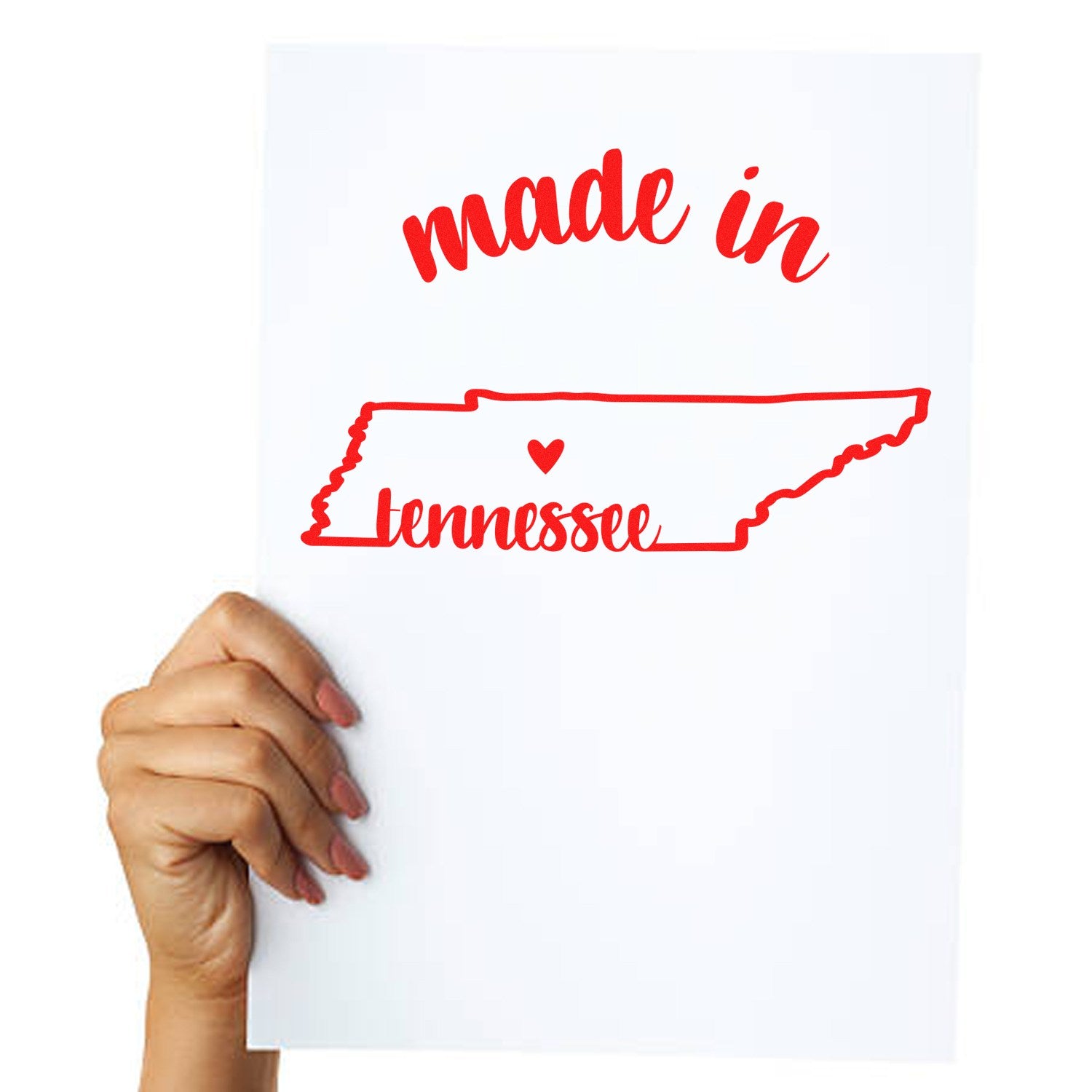 Made in Tennessee Stamp Pre-Inked, featuring red text and a heart within the state outline, held by a hand on white paper.