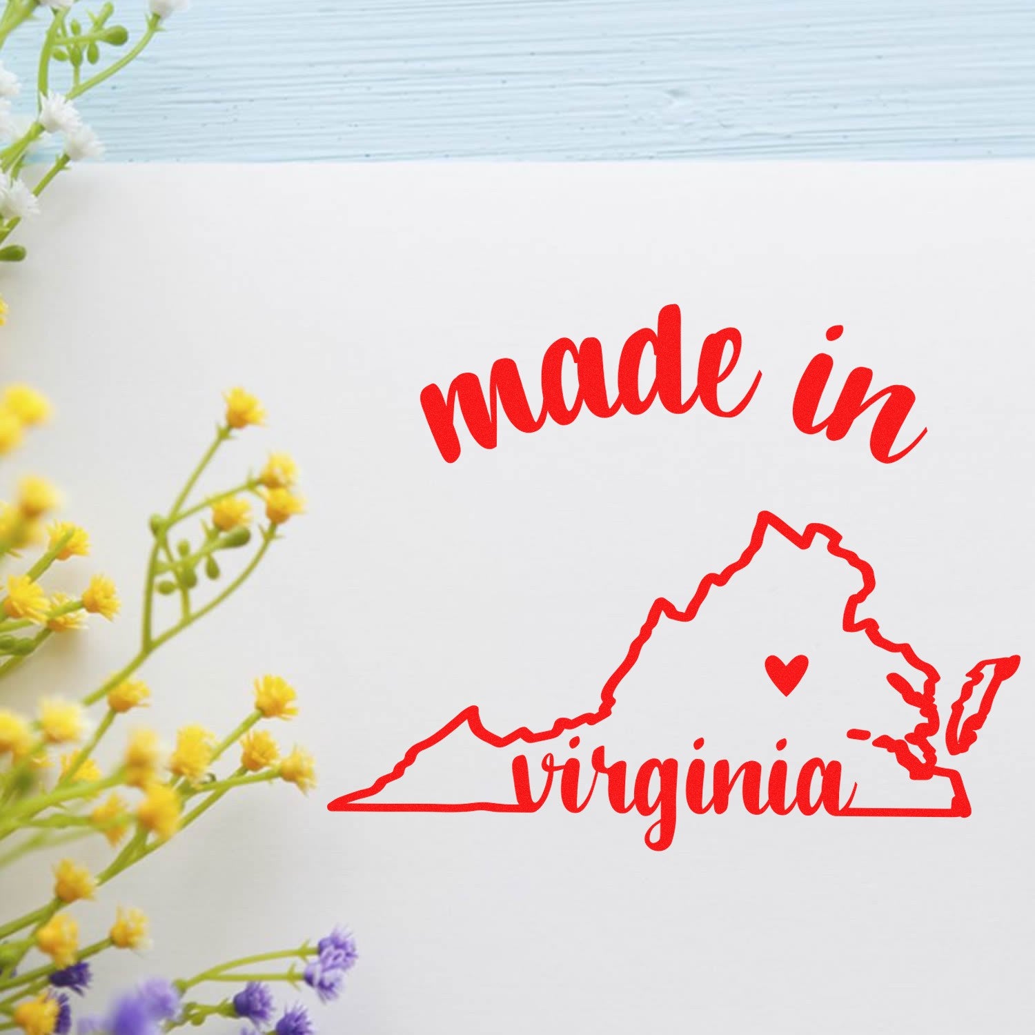 Slim Pre-Inked Stamp Virginia Made in Stamp featuring red 'made in virginia' text with state outline, surrounded by flowers. Perfect for crafts and stationery. High-quality, durable design.