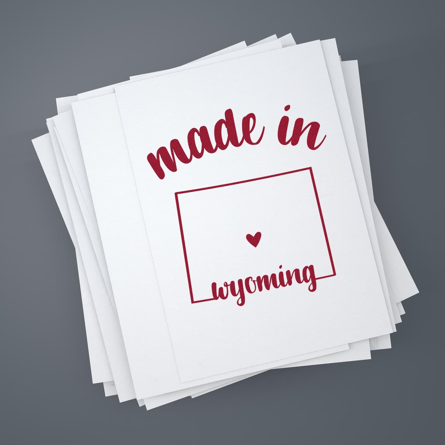 Made with Love in Wyoming Rubber Stamp featuring red text and heart design on white paper, perfect for crafts and branding. Ideal for adding a personal touch to your projects.