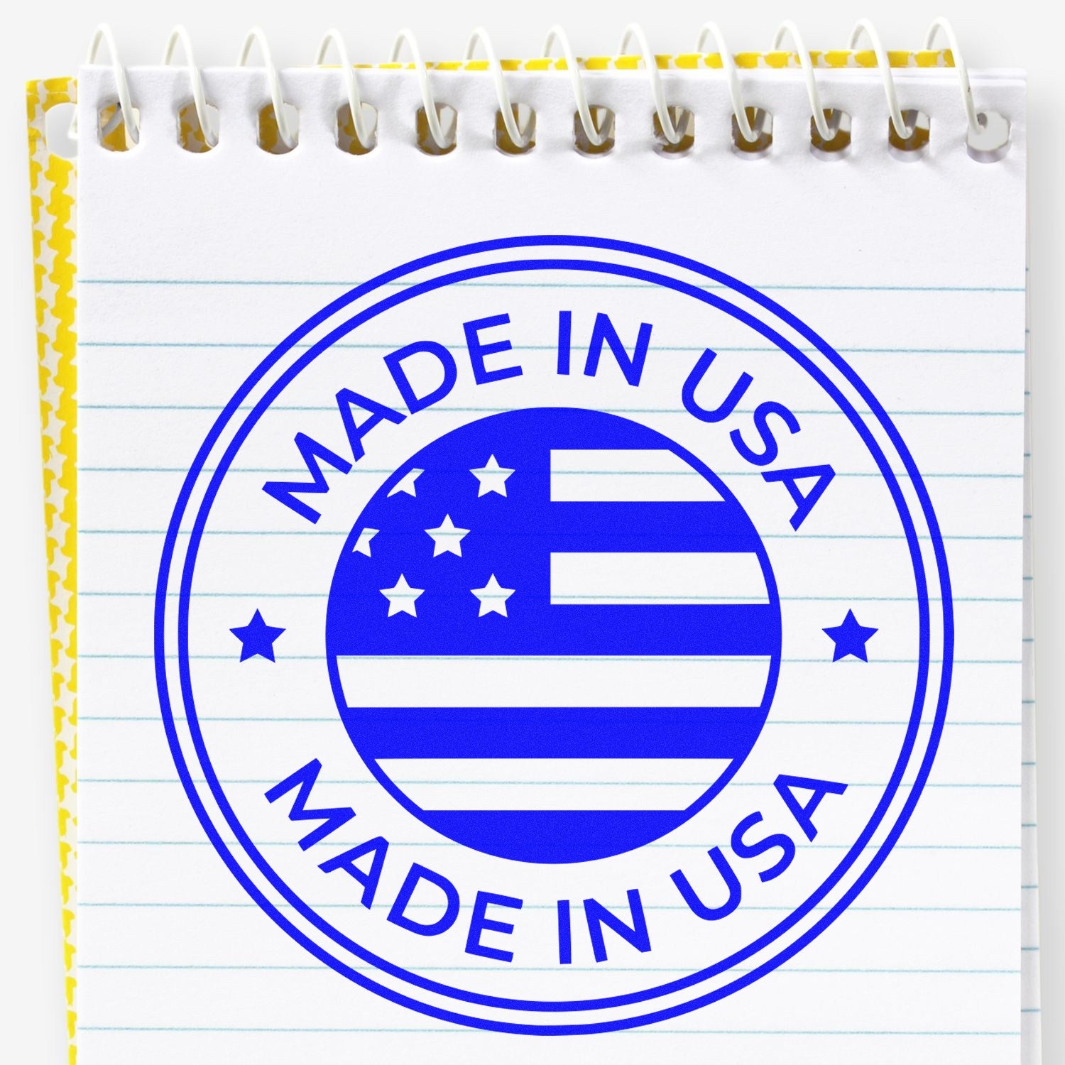 Wood Handle Patriotic Seal Rubber Stamp featuring a Made in USA design with stars and stripes, stamped on a lined notepad. Perfect for adding a patriotic touch to crafts and documents.