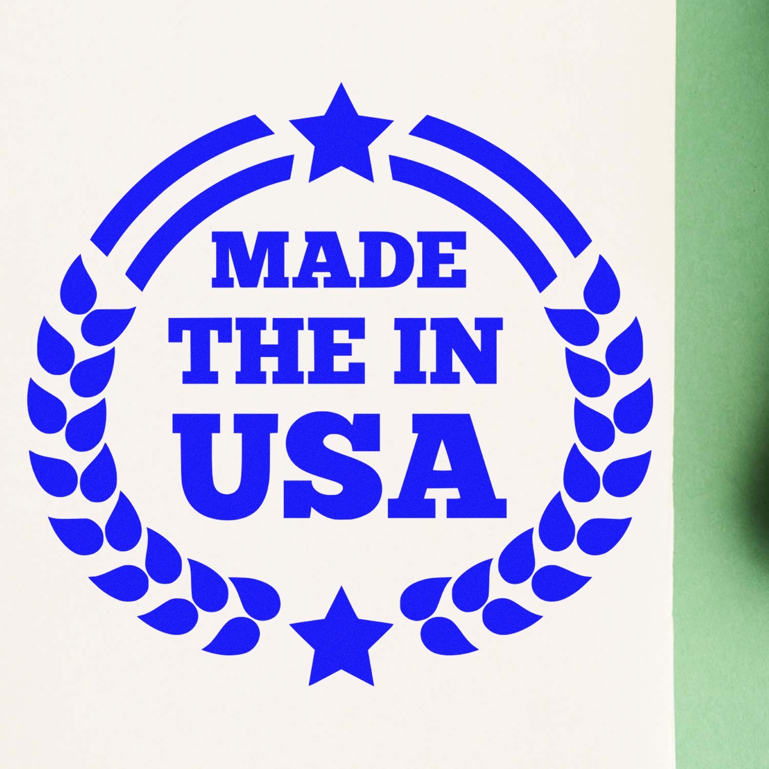 Self-Inking Made In The USA Proudly Stamp in blue ink, featuring a circular design with stars and laurel leaves, stamped on white paper.