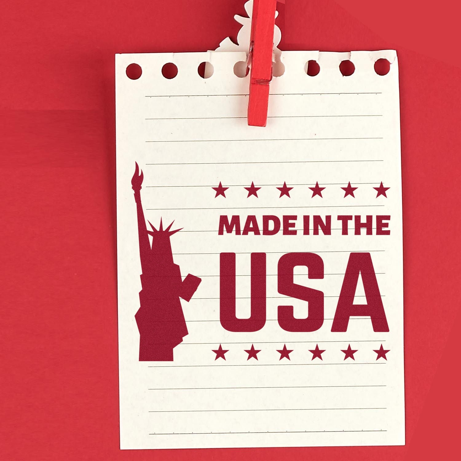 Self-Inking Liberty Made In The USA Stamp imprint on lined paper with red Statue of Liberty silhouette and 'Made in the USA' text, showcasing patriotic design.