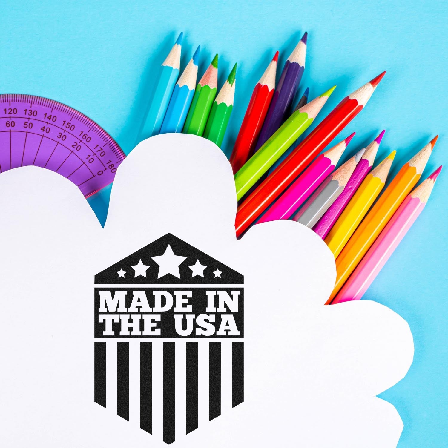 Self-Inking Patriotic Pride Seal Stamp with 'Made in the USA' design, surrounded by colorful pencils on a blue background.