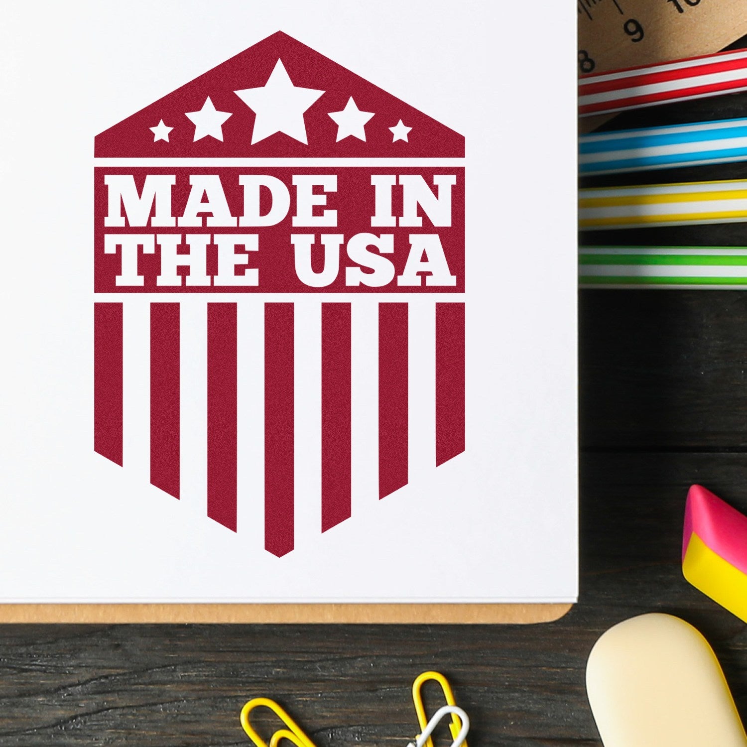 Self-Inking Patriotic Pride Seal Stamp with 'Made in the USA' design, featuring stars and stripes, on a white paper background with colorful stationery items.