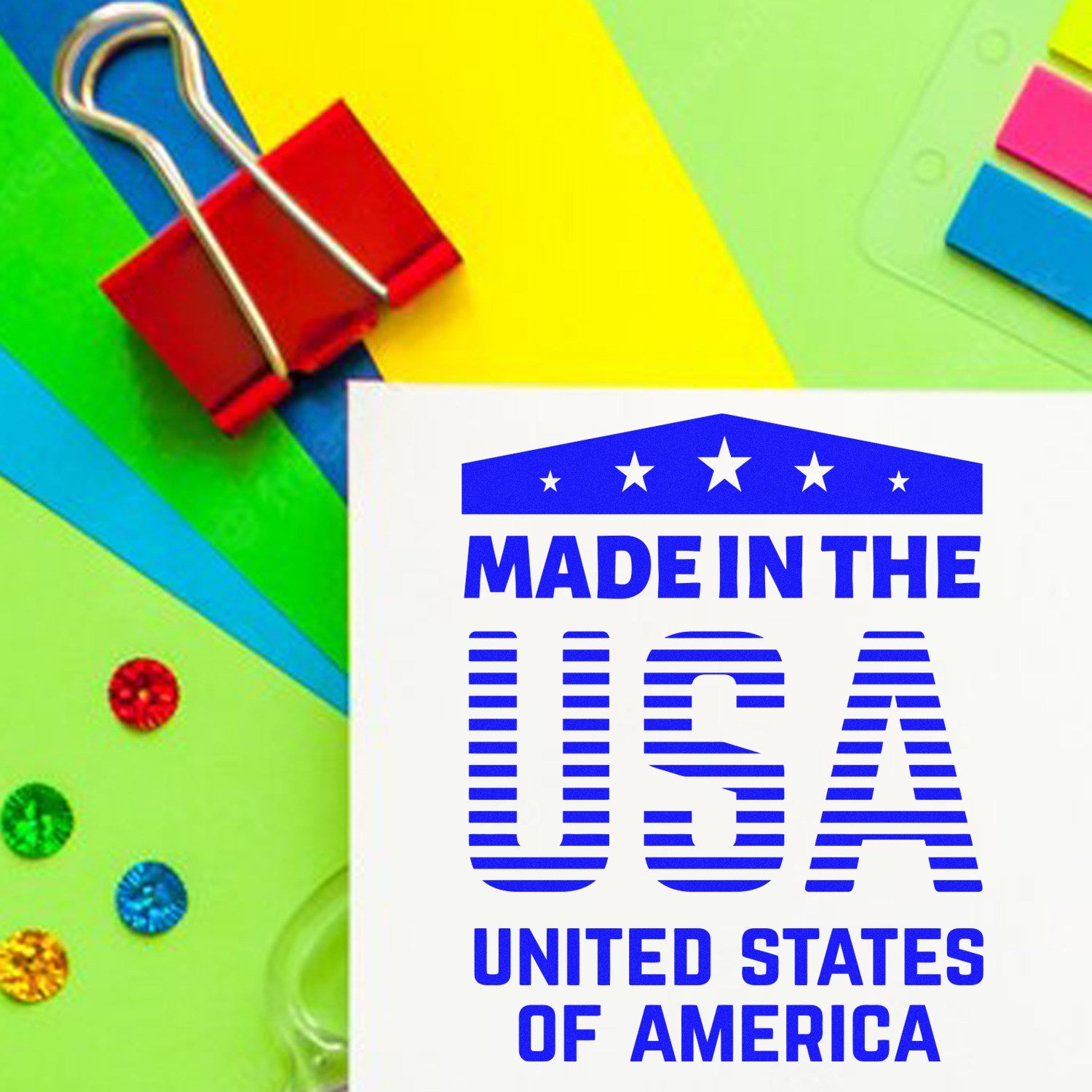 PSI Pre-Inked Patriotic Pride Stamp displaying Made in the USA text in blue on a colorful background with office supplies, showcasing American pride and quality craftsmanship.