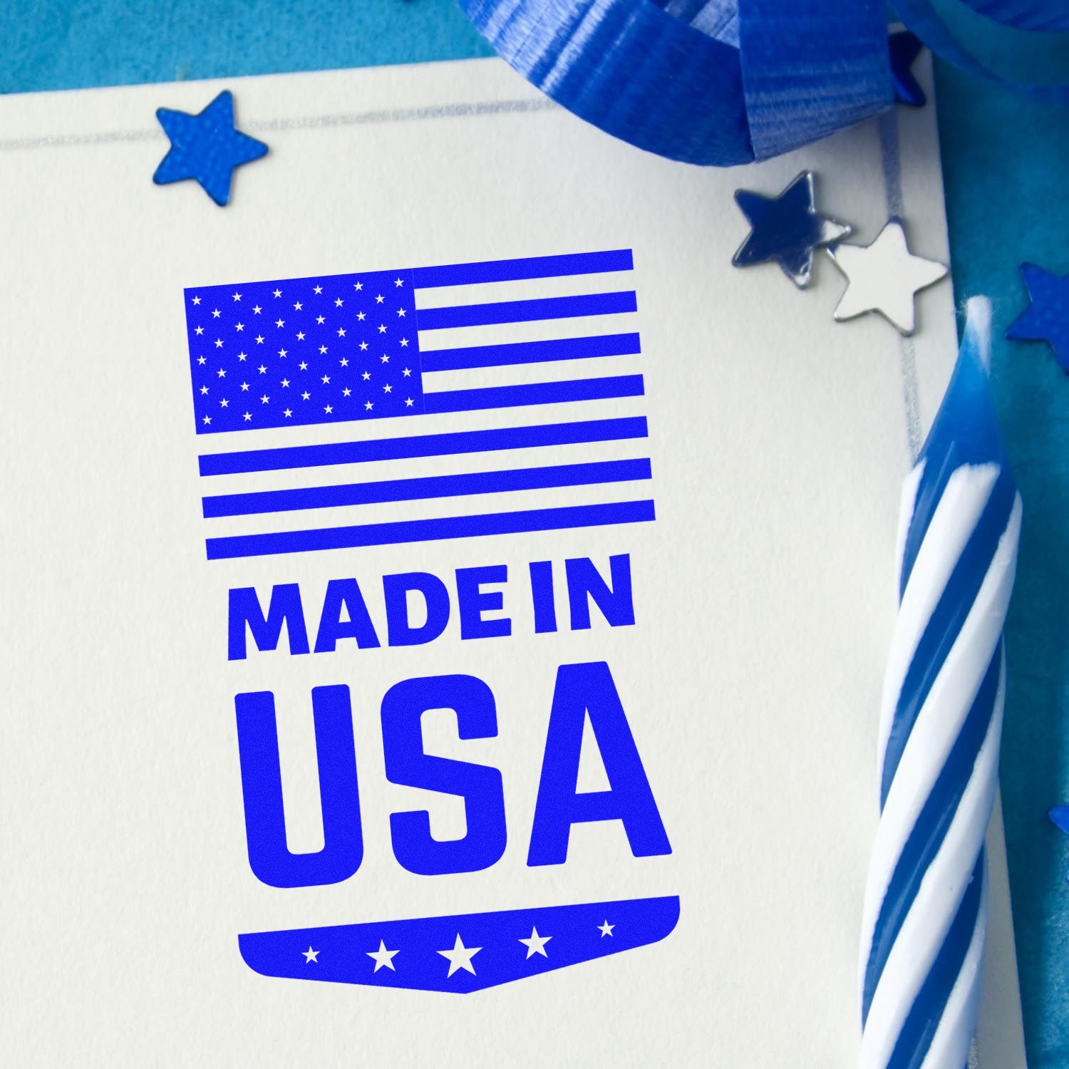 Wood Handle Made In USA Emblem Rubber Stamp with blue ink imprint on paper, featuring an American flag and stars. Ideal for patriotic crafts and branding.