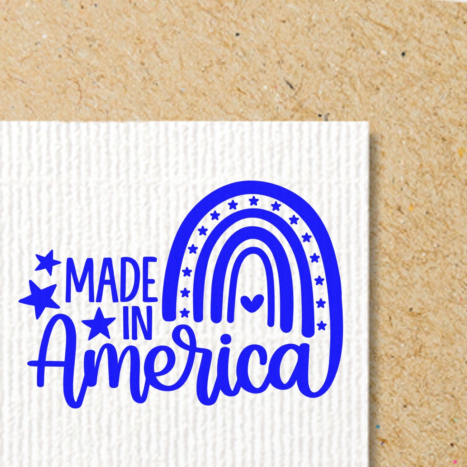 PSI Pre-Inked American Pride Rainbow Stamp featuring a blue Made in America design with stars and a rainbow on a textured background. Perfect for patriotic crafts and projects.