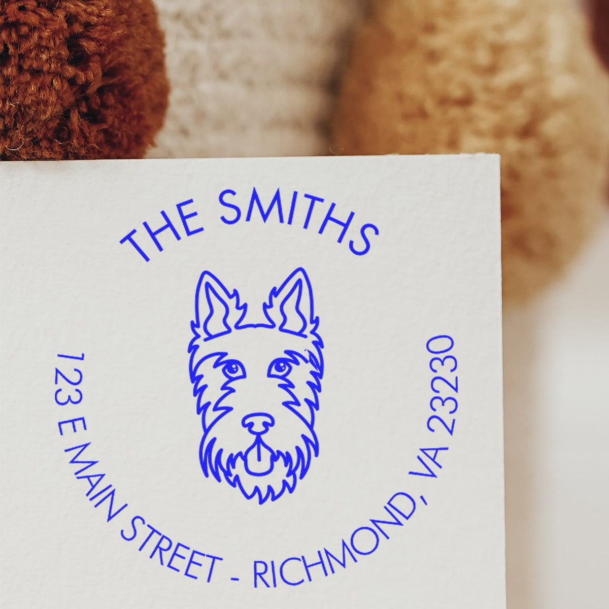Blue custom stamp and seal with dog logo for The Smiths, 723 E Main Street, Richmond, VA 23230, on white paper.