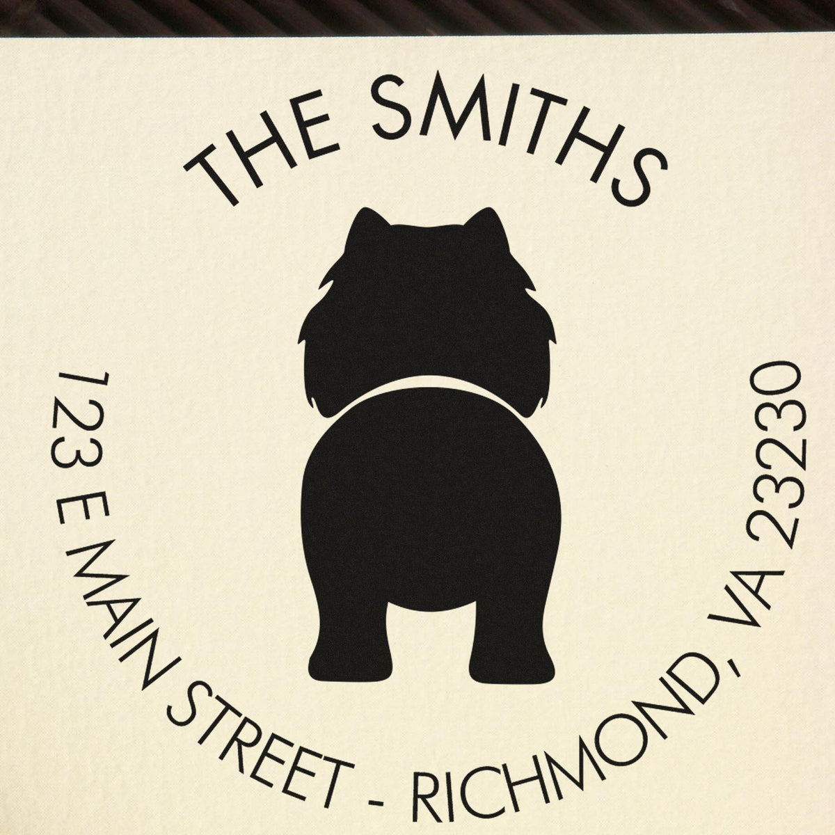 Black circular stamp seal for The Smiths, with bulldog silhouette and address text on cream background.