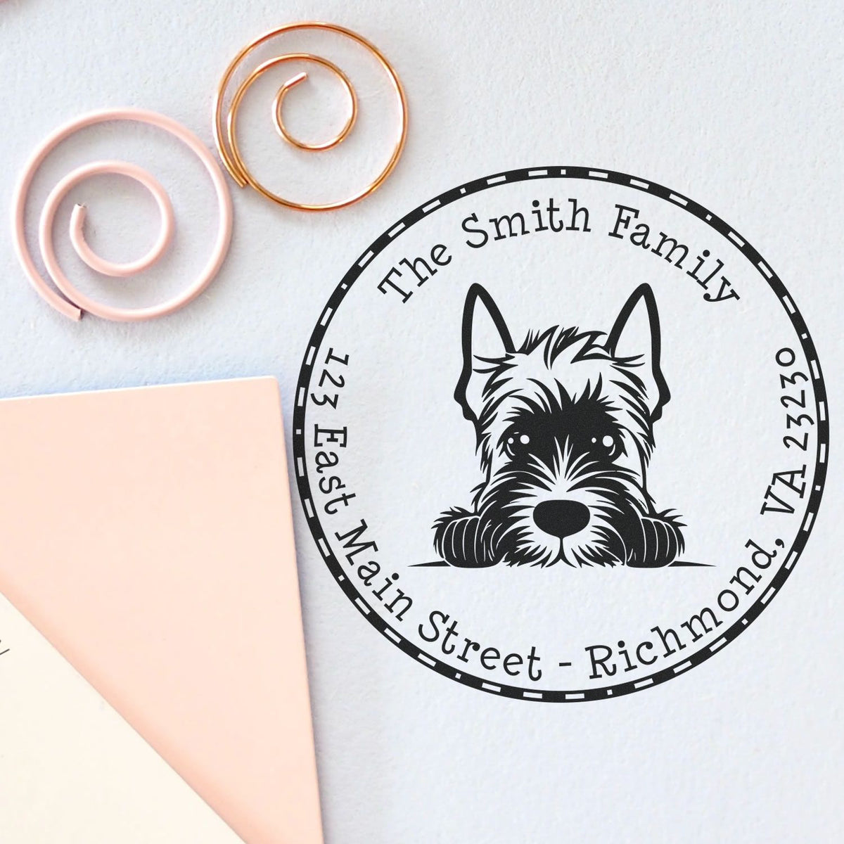Custom black dog family address stamp and seal design with pastel pink and gold wax seal spirals on white paper.