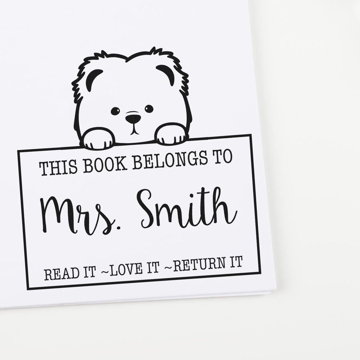 Black-and-white personalized book stamp with teddy bear and This Book Belongs to Mrs. Smith text