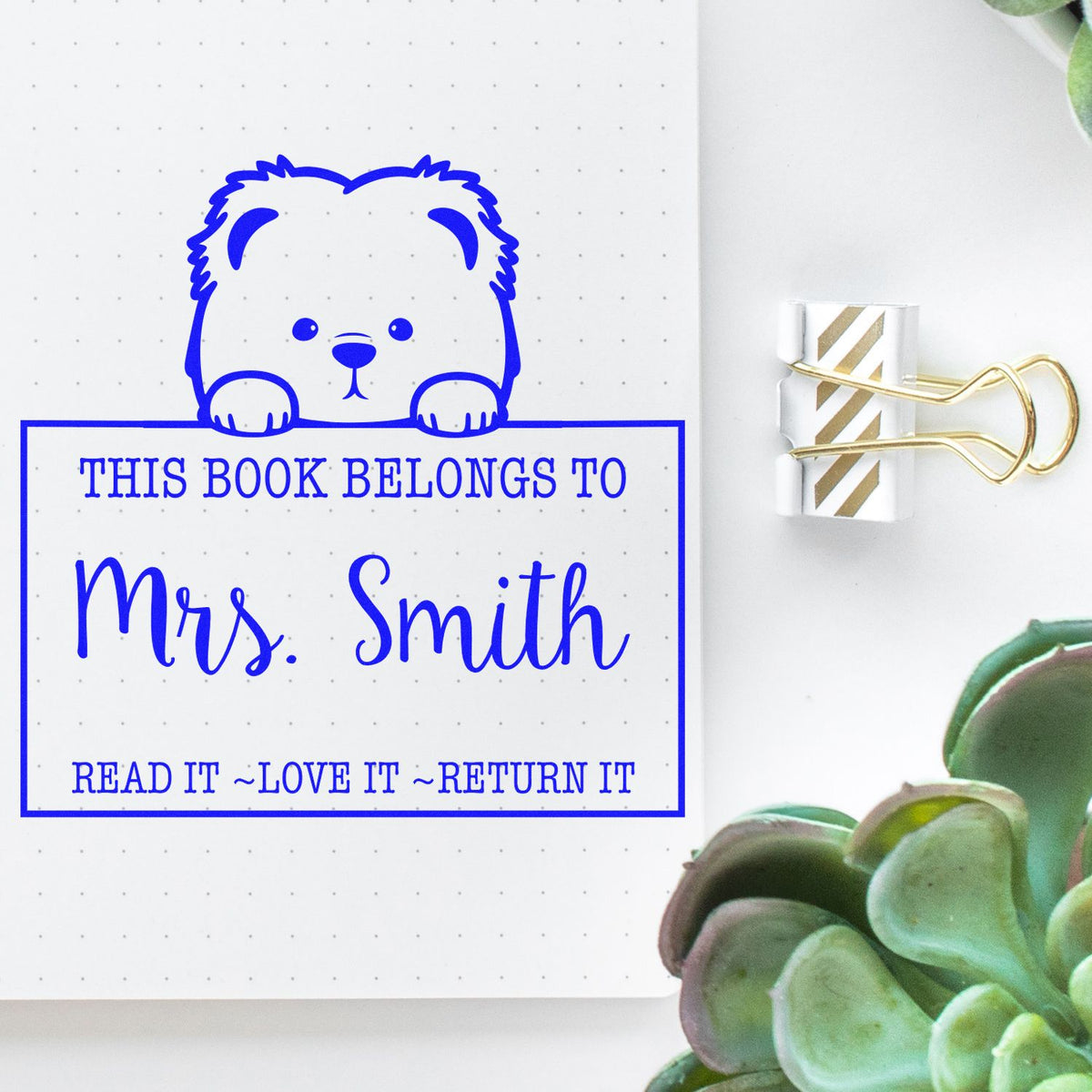 Blue bear book stamp seal reading This Book Belongs to Mrs. Smith on dotted paper, clipped with gold binder clip.