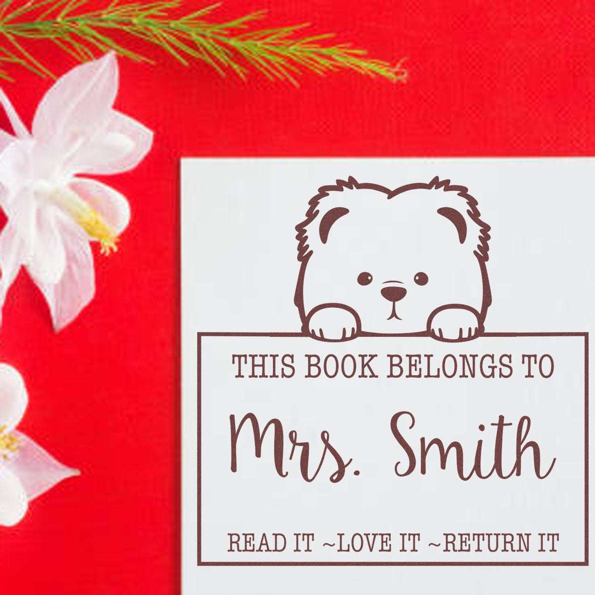 Red book stamp and seal with brown bear design and This Book Belongs to Mrs. Smith text on white.