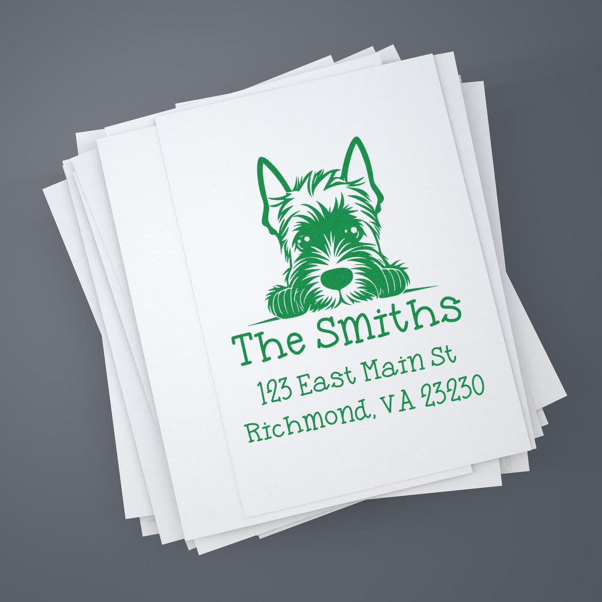 Green custom self-inking stamp and seal on stacked white paper, with dog logo and The Smiths address in Richmond, VA