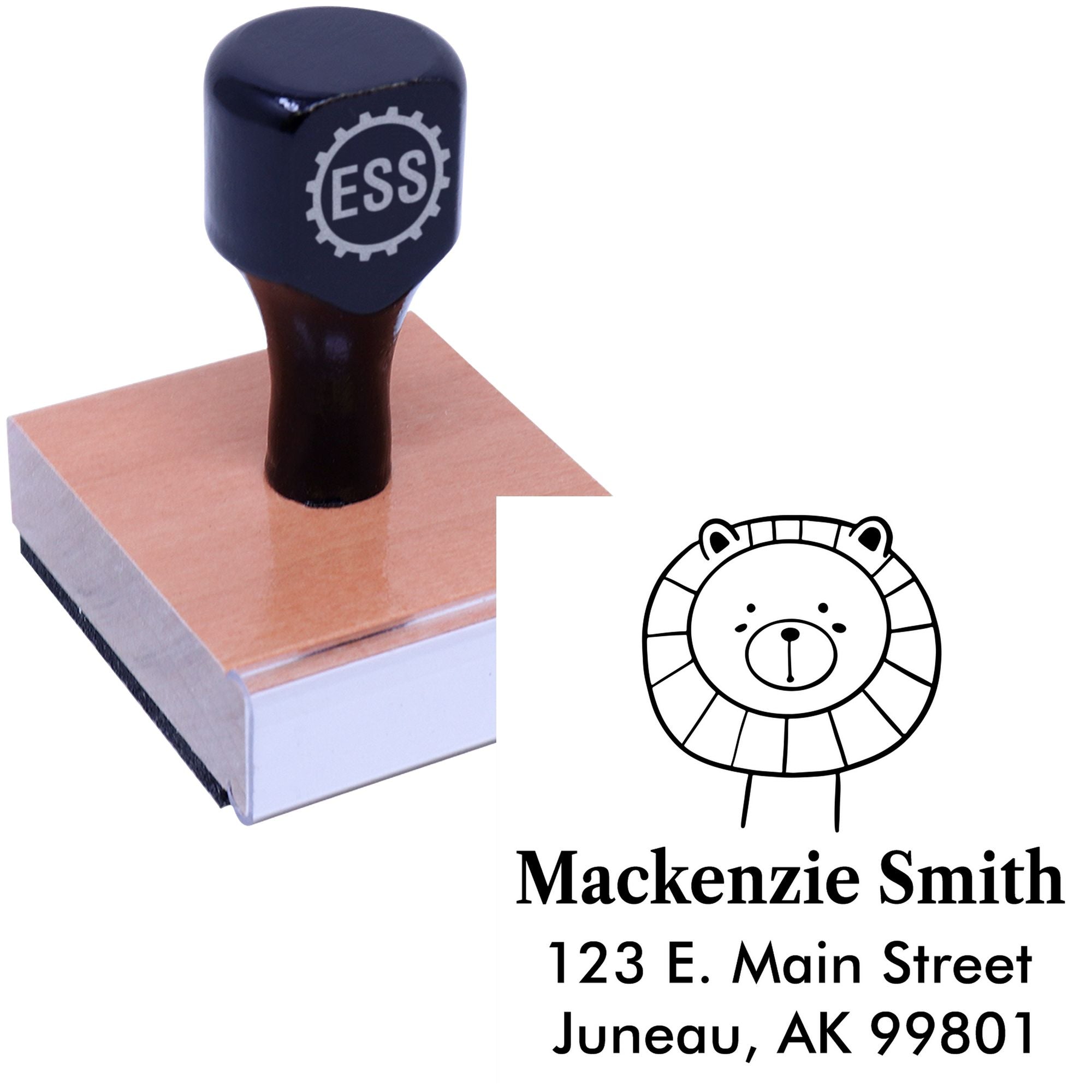 Wood handle stamp featuring a Lovable Lion's Lair cartoon animal design. The made-to-order return address stamp is shown with "Mackenzie Smith, 123 E. Main Street, Juneau, AK 99801." Ideal for a customized mailing stamper.