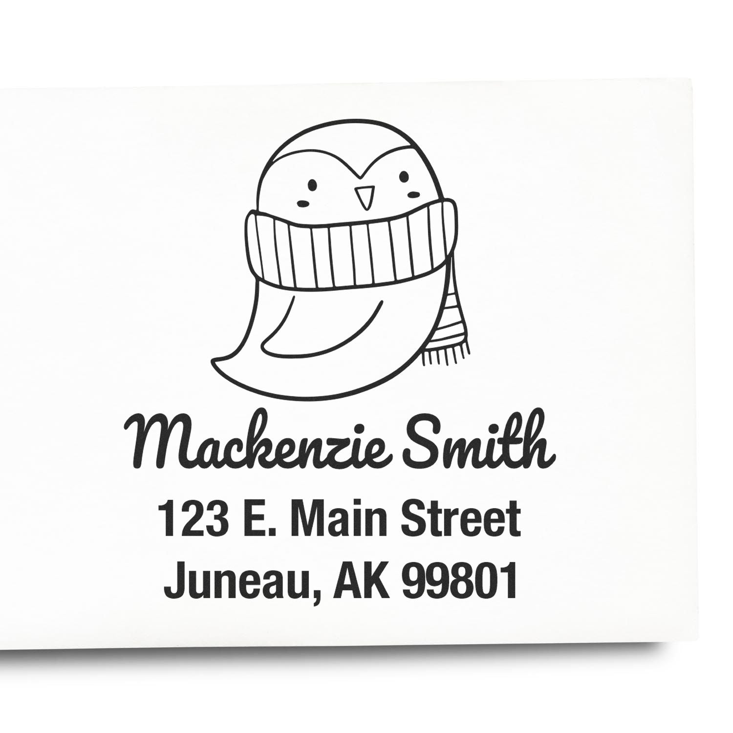Self-Inking Cartoon Animal Pretty Penguin Custom Made Address Stamper featuring a cute penguin in a scarf. Text reads "Mackenzie Smith, 123 E. Main Street, Juneau, AK 99801." Ideal for a Customizable New Address Stamp.