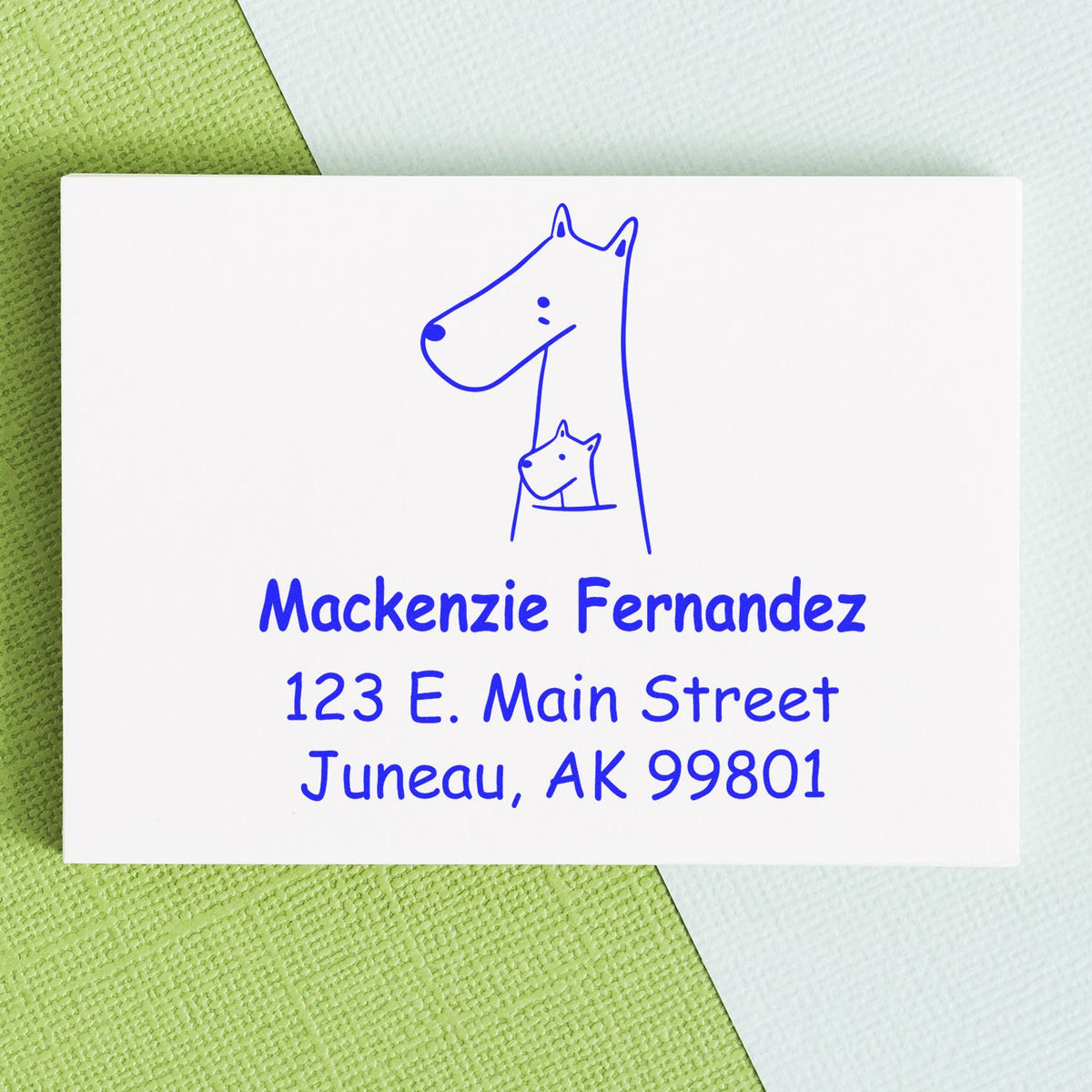 Snuggly Kangaroos Pre-Inked Customized Address Stamp featuring a kangaroo design with a joey. The Custom Mailing Stamp displays the name "Mackenzie Fernandez" and address "123 E. Main Street, Juneau, AK 99801" in blue ink on a textured background.