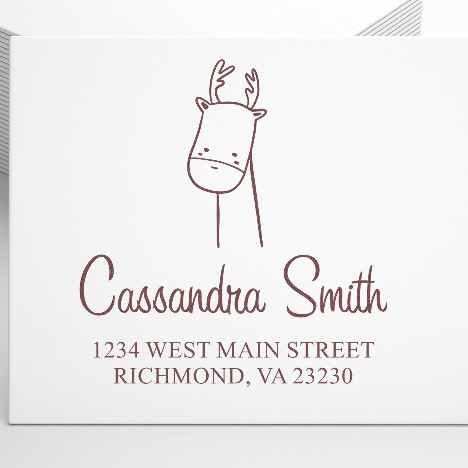 Self-Inking Cartoon Animal Darling Deer Personalized Mailing Stamp on an envelope. The Customizable Home Stamp features a cute deer illustration above the name "Cassandra Smith" and an address in Richmond, VA.